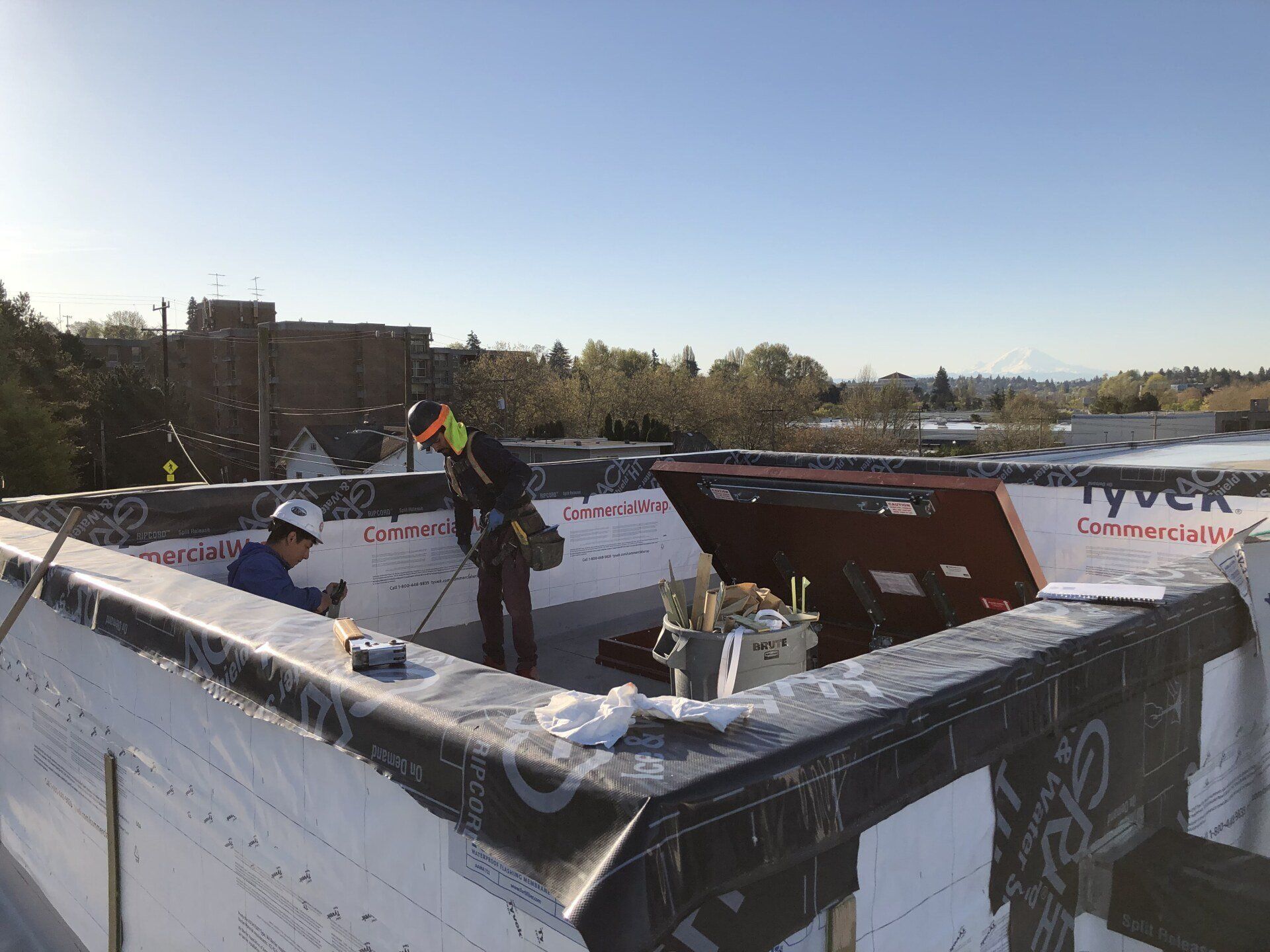 A man is working on the roof of a building.