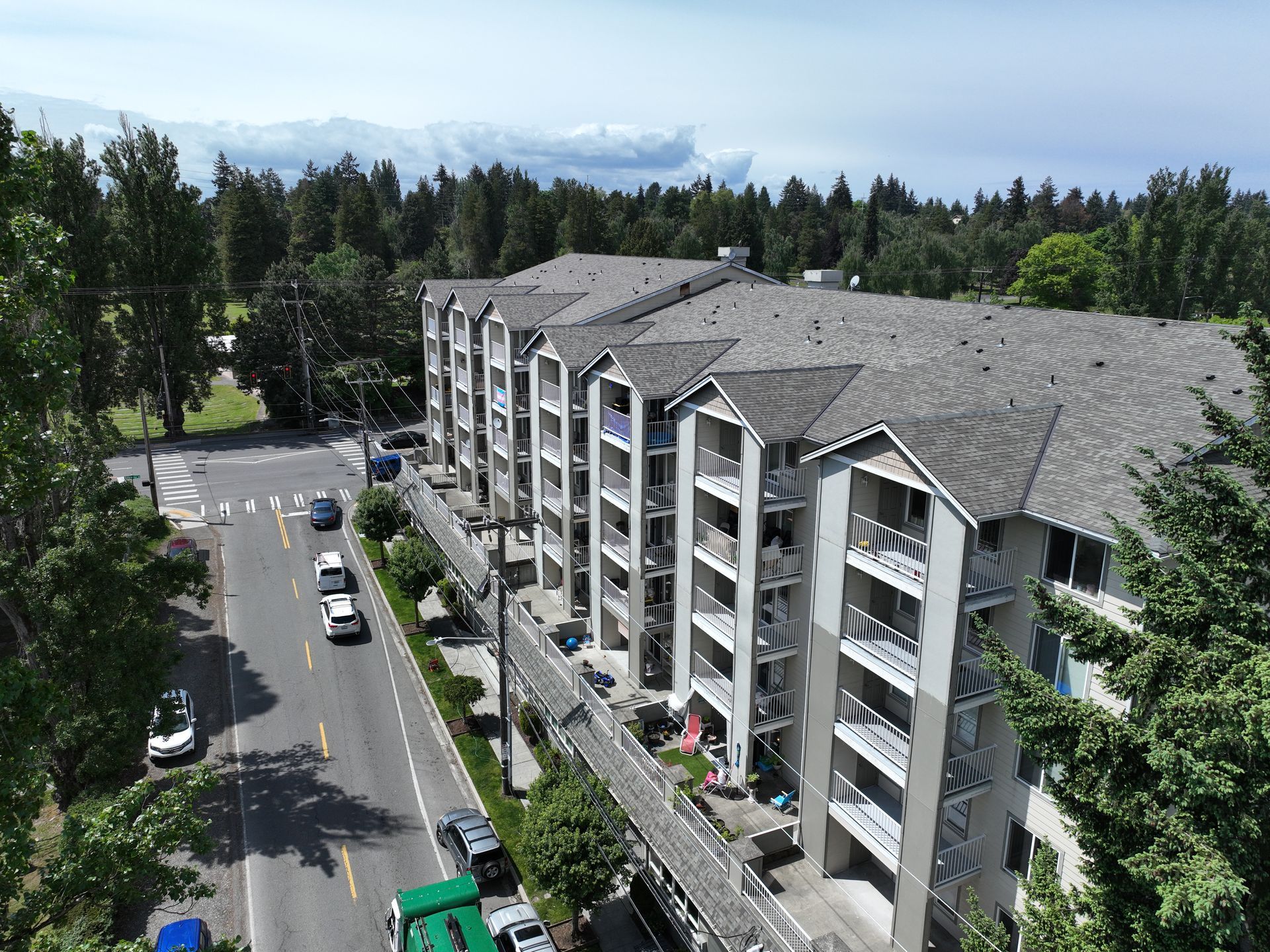 An aerial view of a large apartment building surrounded by trees.