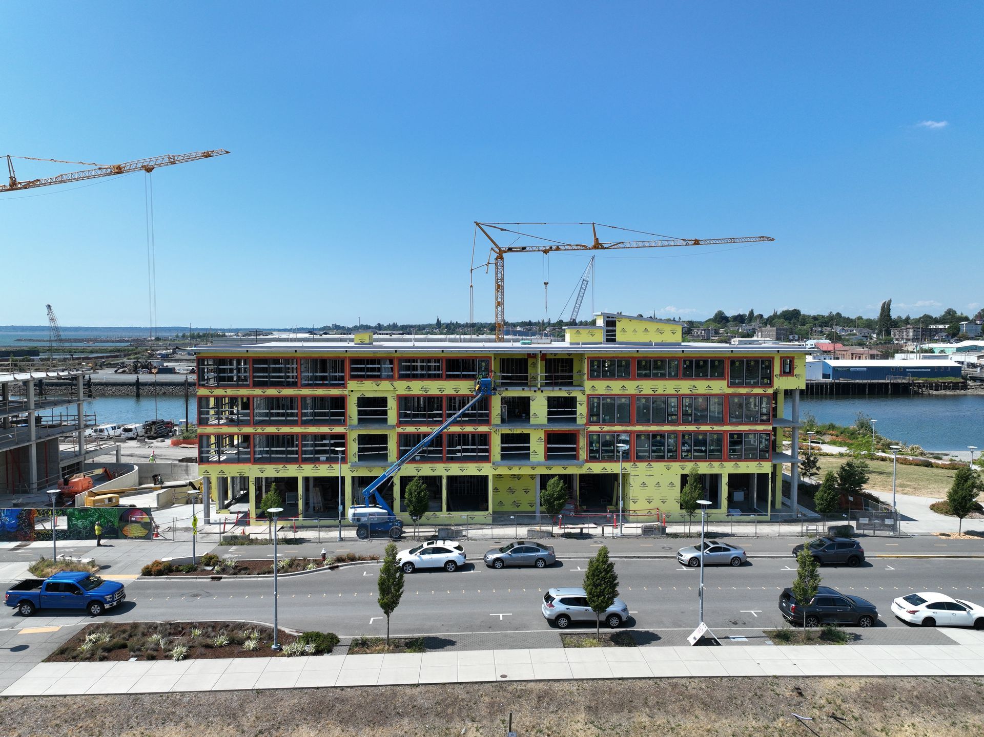 A large building is being built next to a body of water