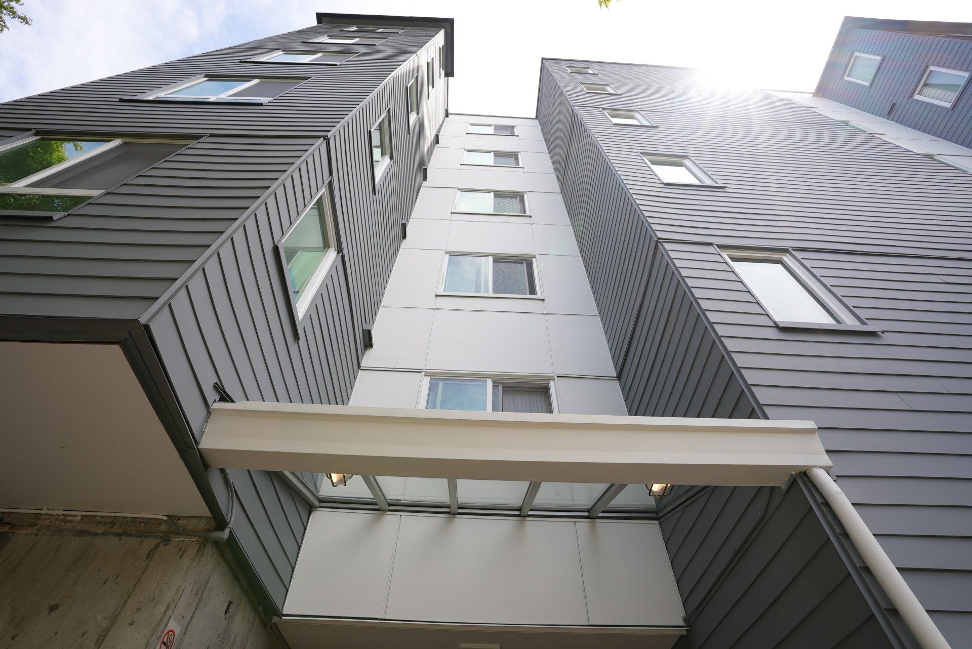Looking up at a tall building with lots of windows
