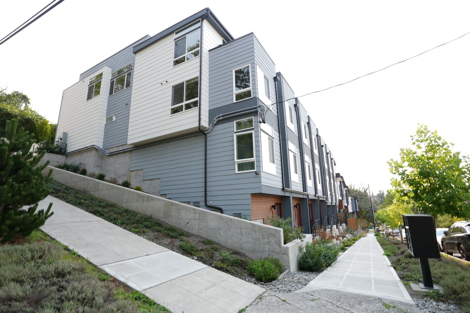 A large apartment building with a sidewalk leading to it