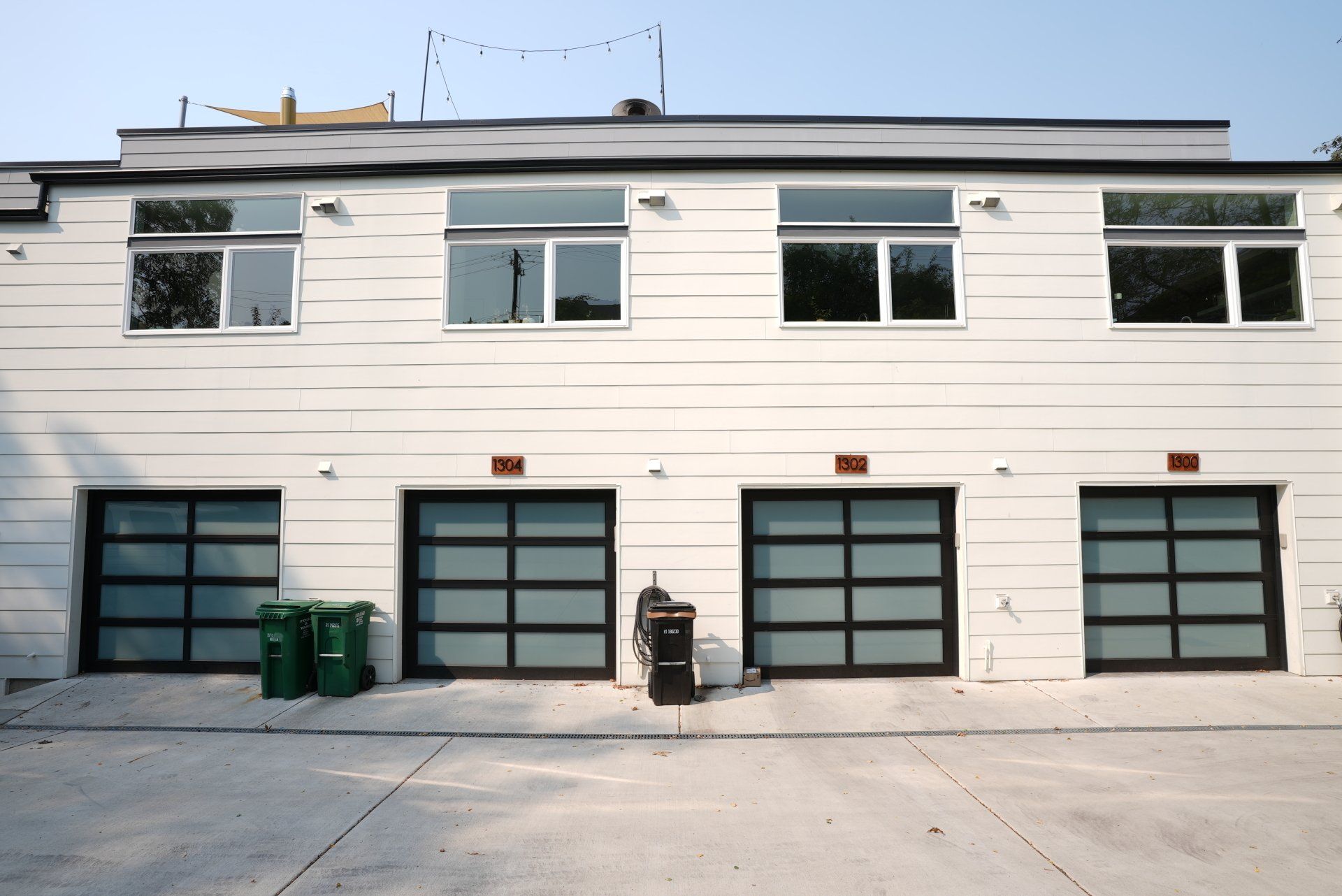 A white building with a lot of windows and garage doors