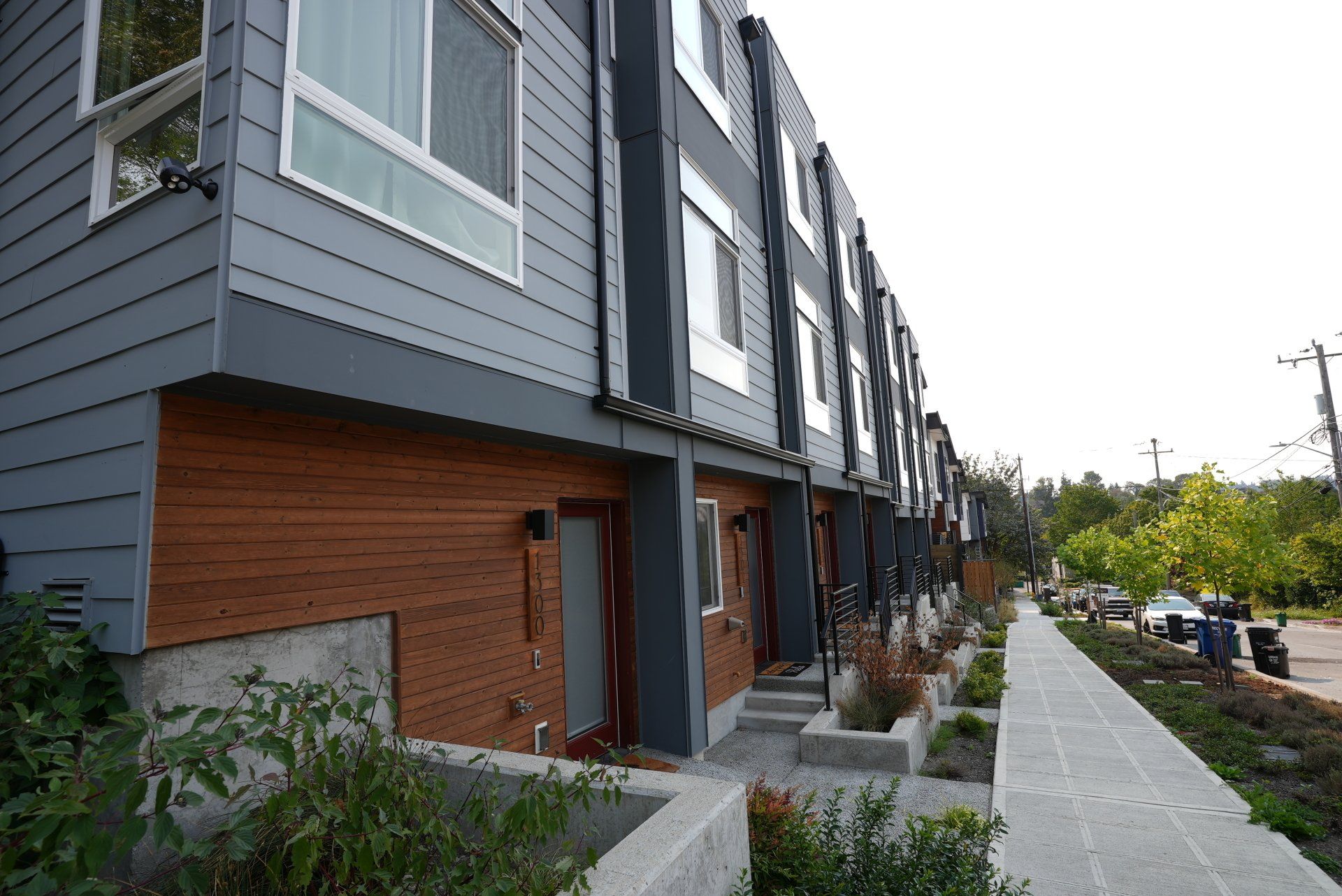 A row of houses with a sidewalk in front of them