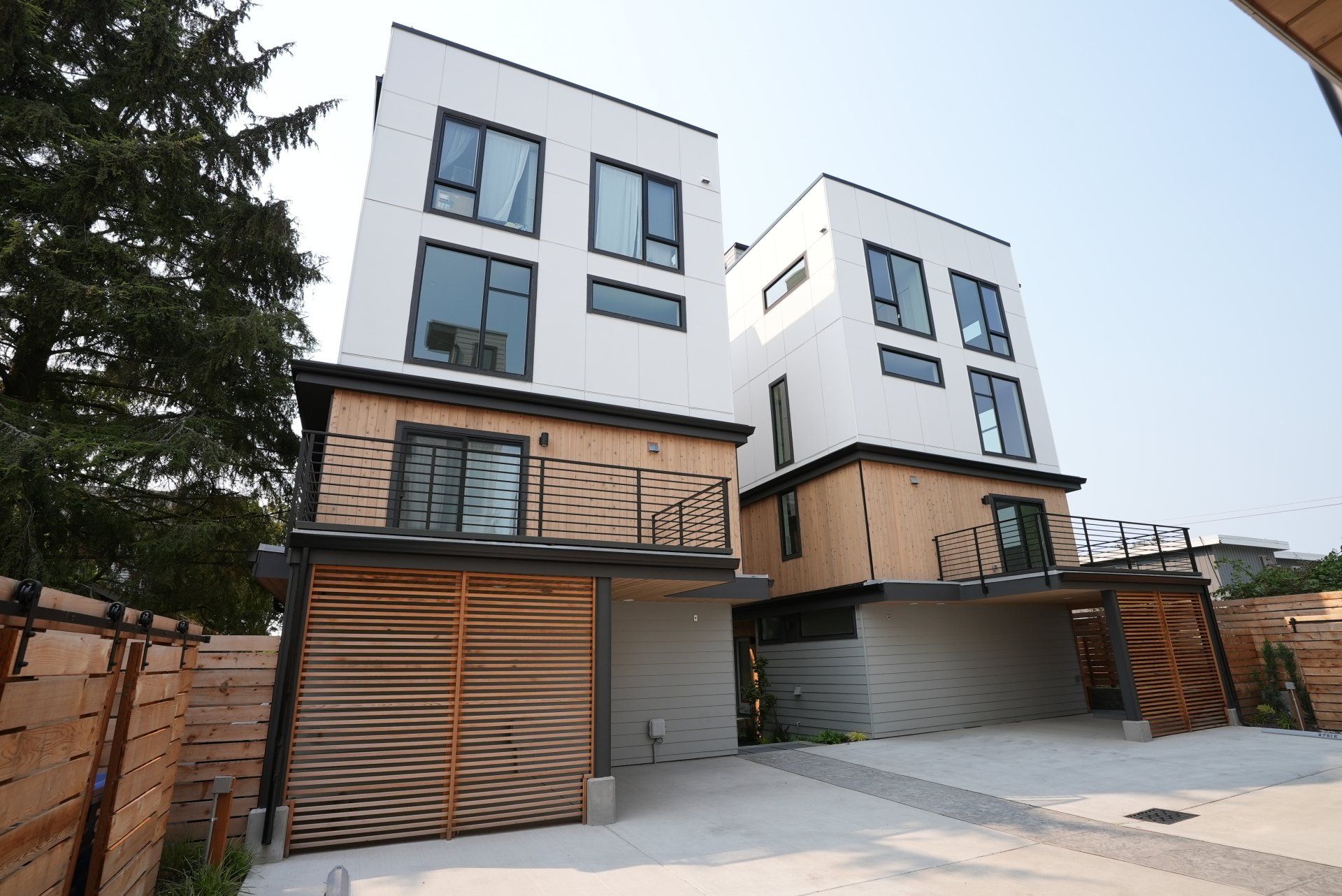 A building with a lot of windows and a wooden fence in front of it