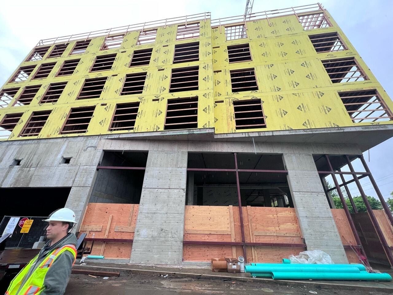 A large building is being built with a crane attached to it.