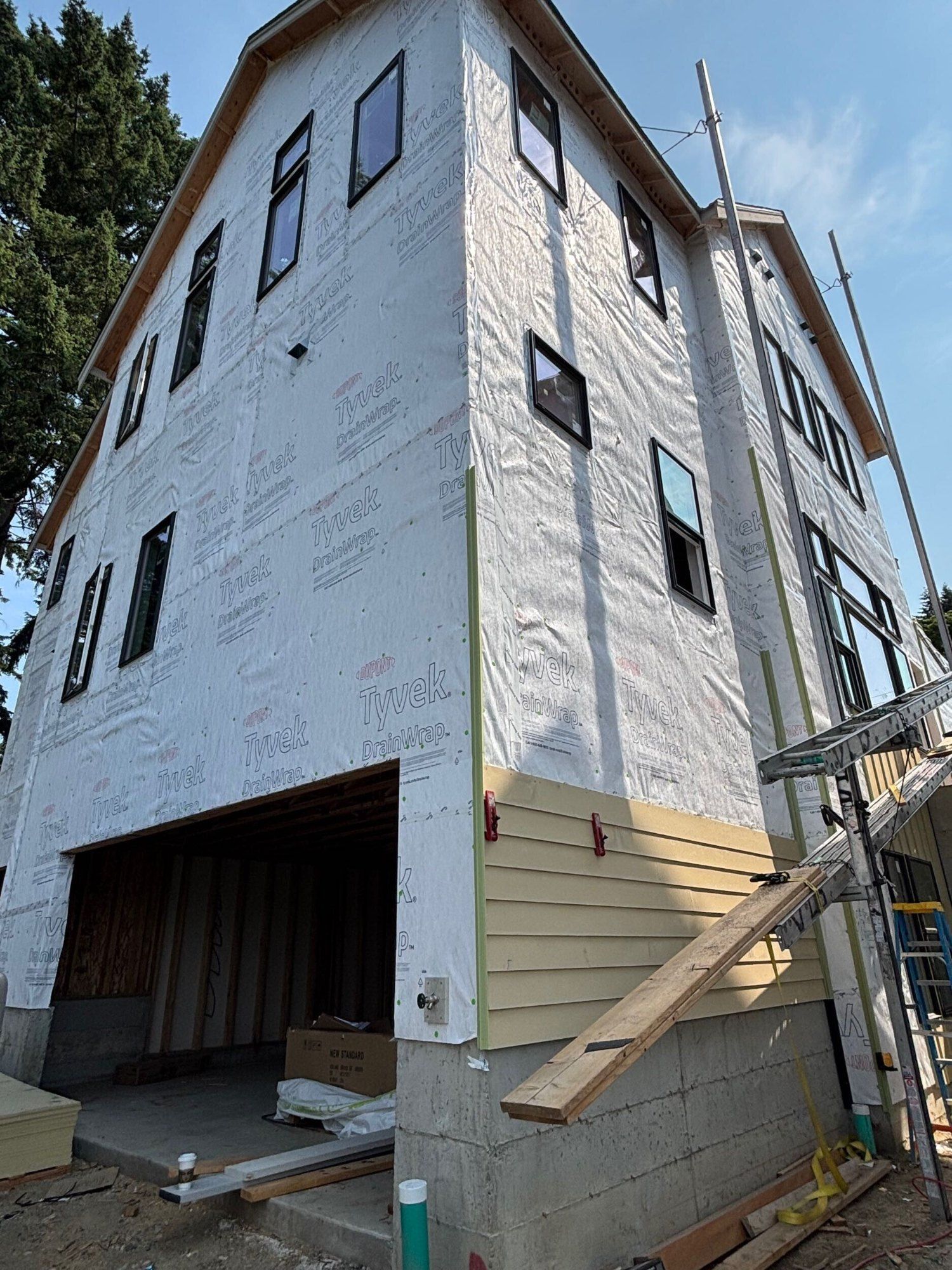 Completed siding, windows, slim brick, drywall & concrete at Lumina Townhomes in Bothell, WA by United Seattle