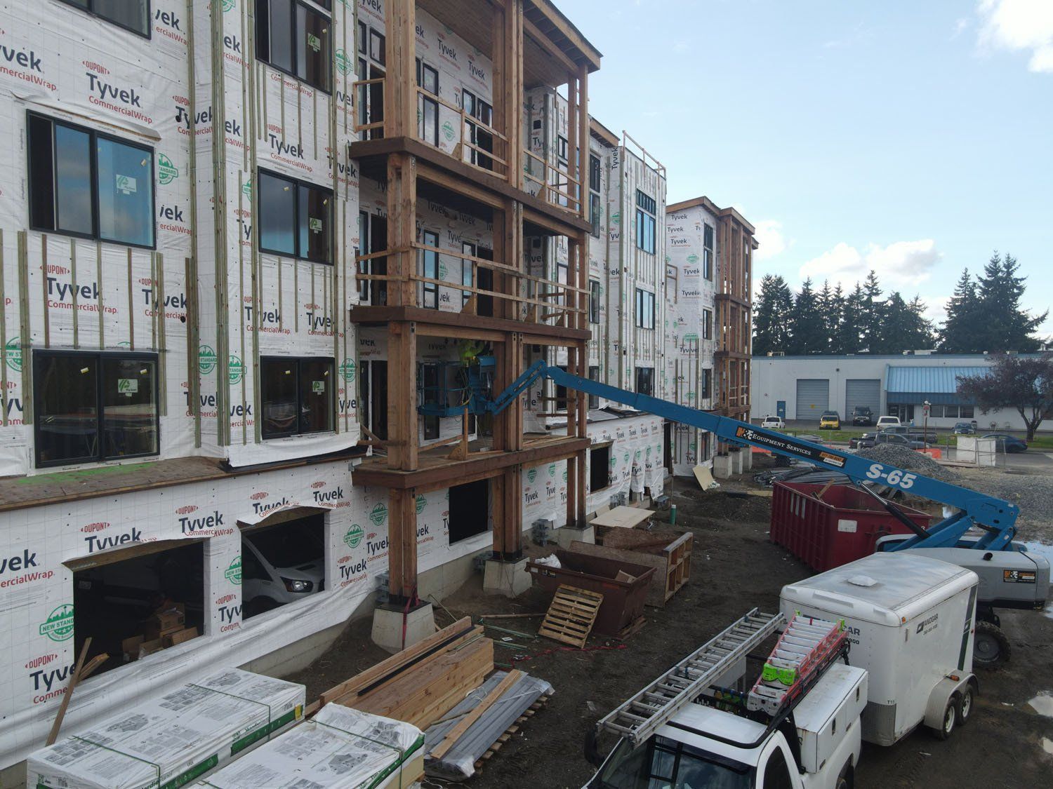 An aerial view of a building under construction with a truck parked in front of it.