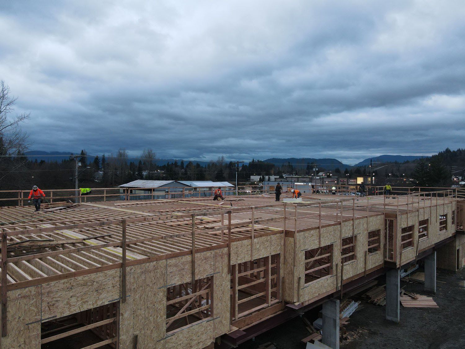 An aerial view of a building under construction on a cloudy day.