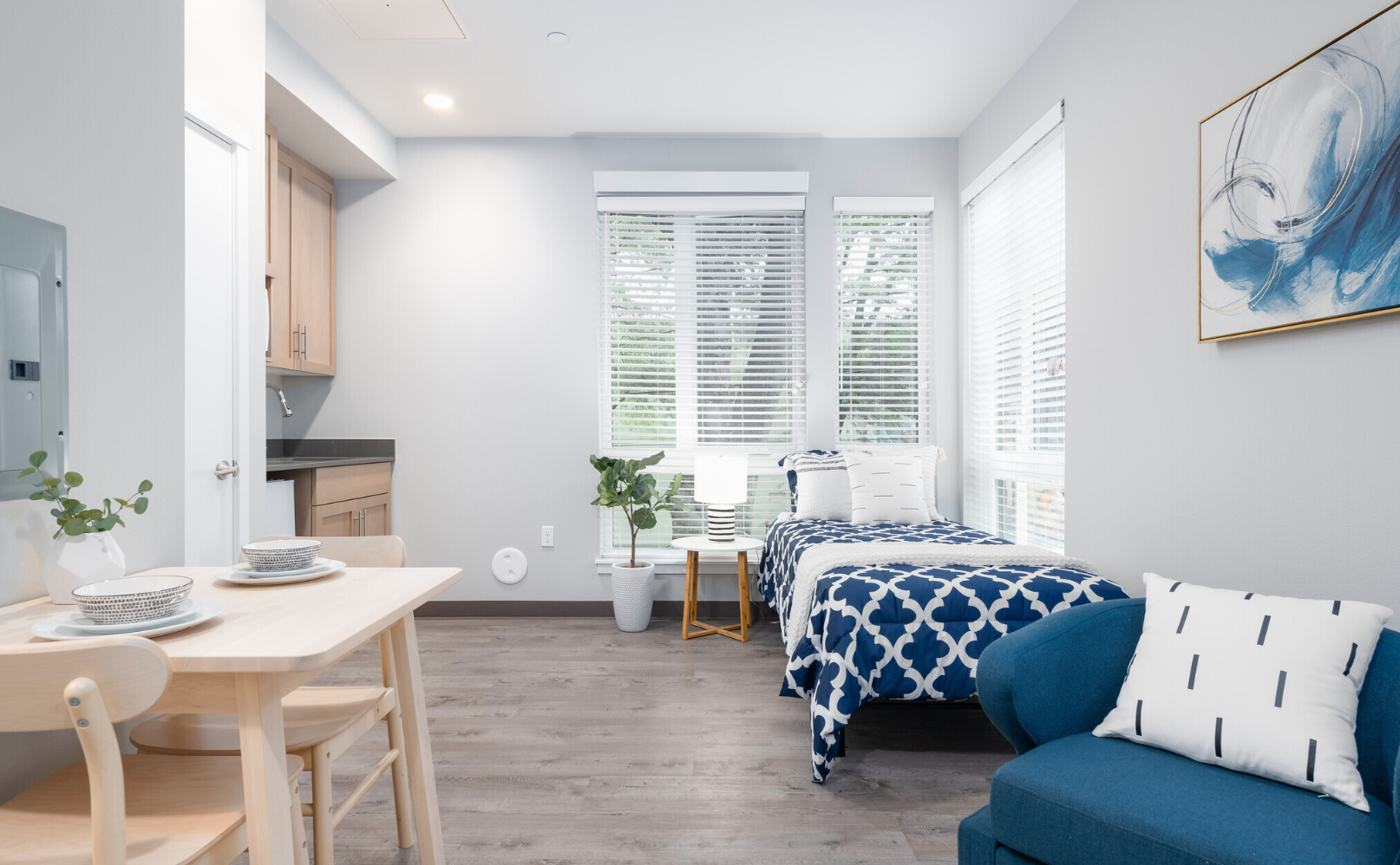 A living room with two beds , a table and chairs.