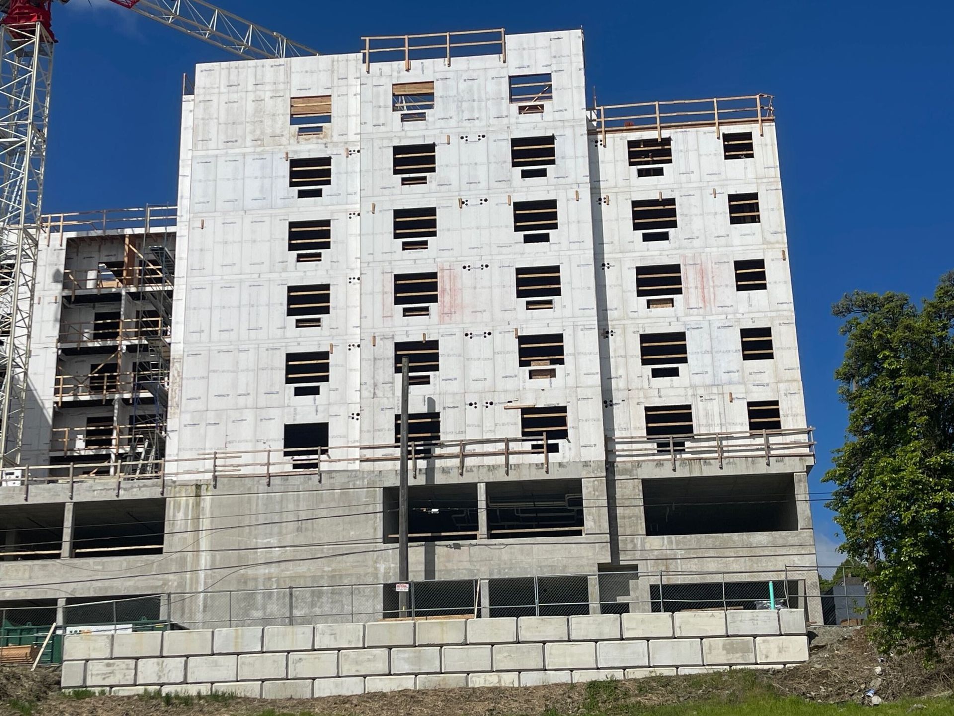 A large building is being built with a crane attached to it.