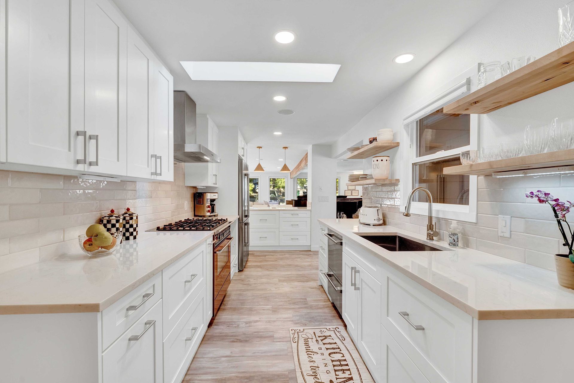 A kitchen with white cabinets and stainless steel appliances.