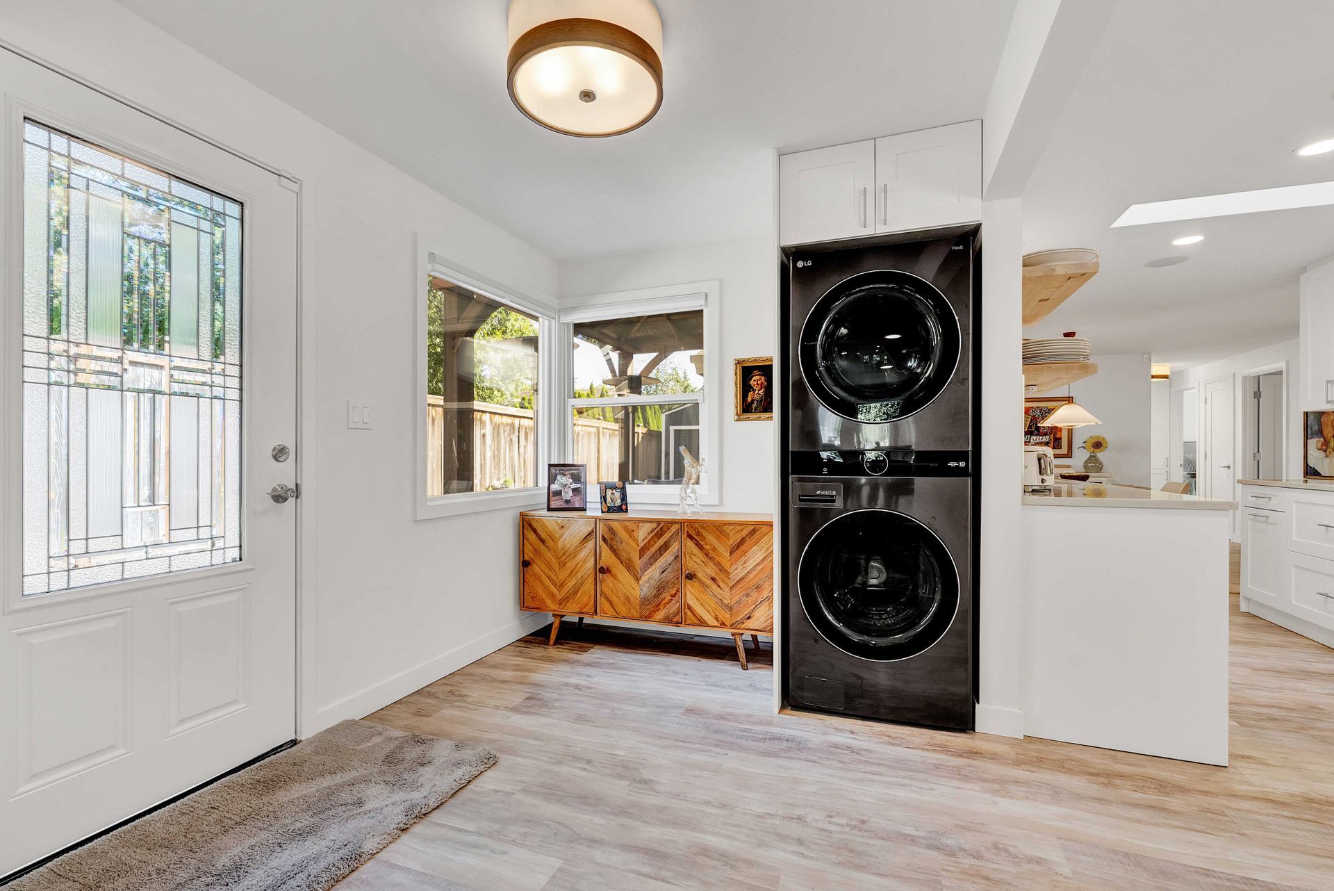 A laundry room with a washer and dryer stacked on top of each other.