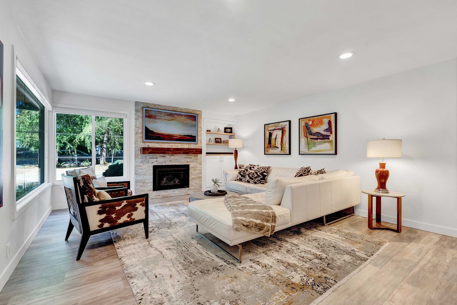 A living room with a couch , chairs , and a fireplace.