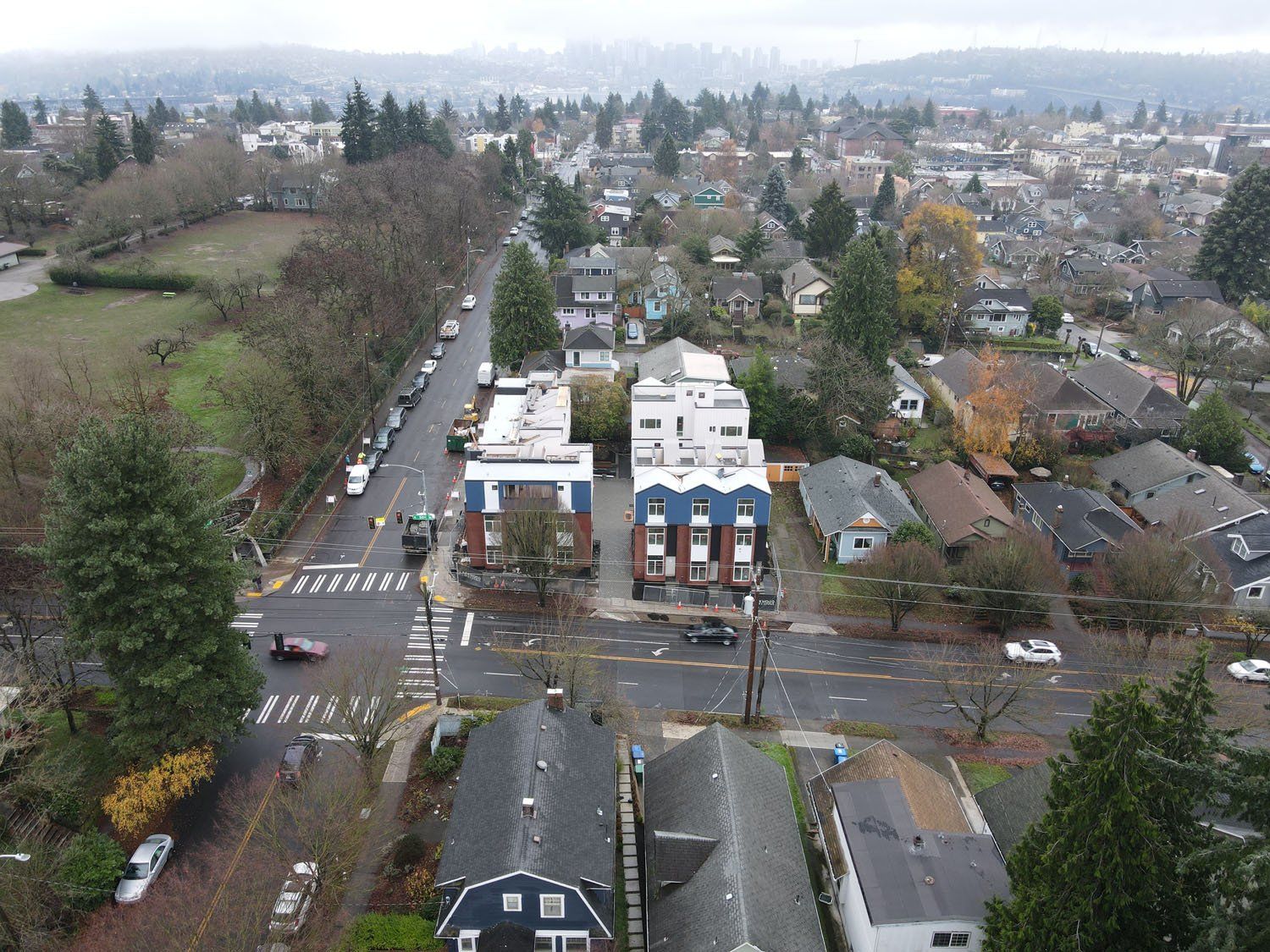 An aerial view of a residential area with a city in the background.