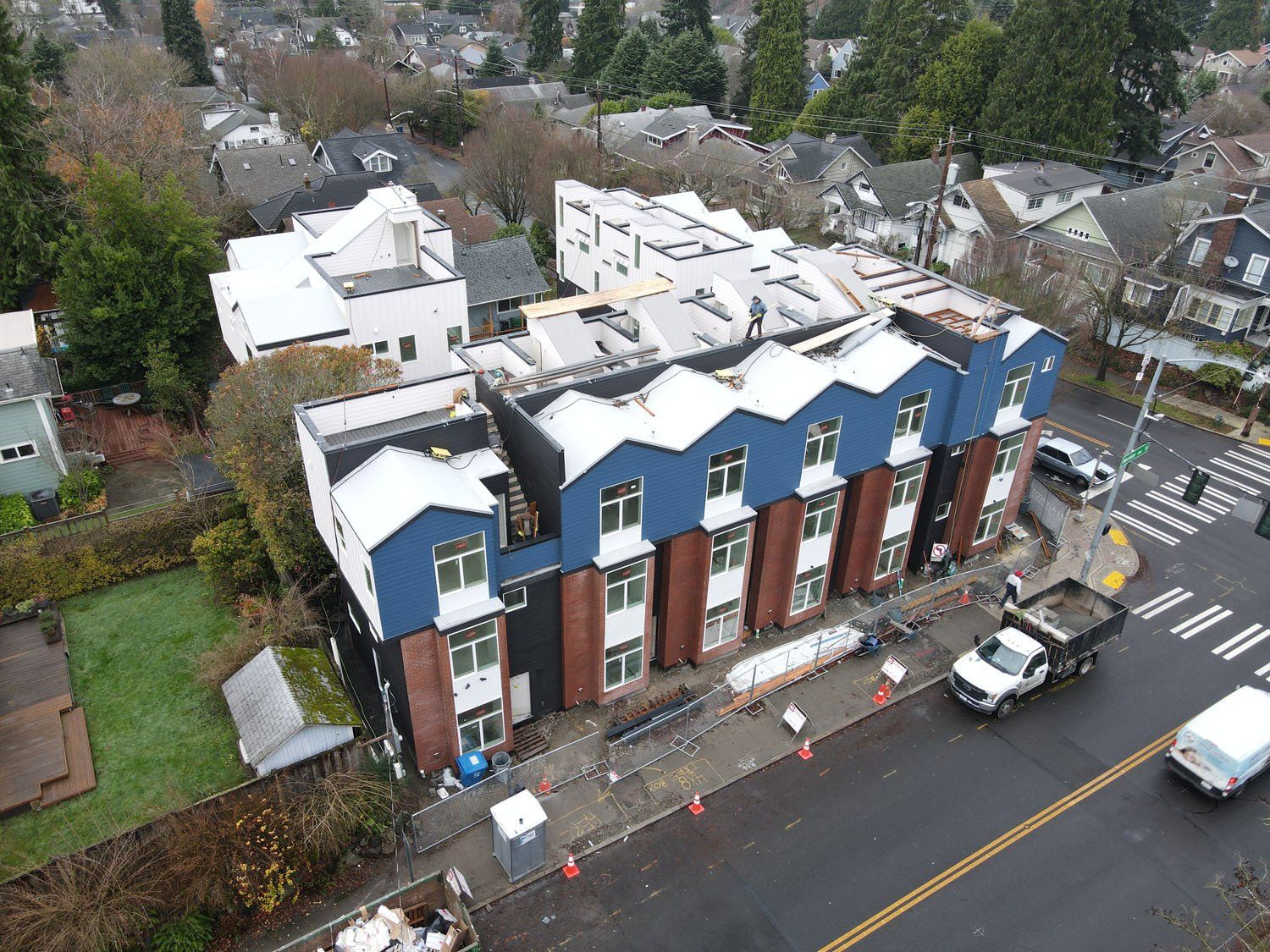 An aerial view of a building under construction in a city.
