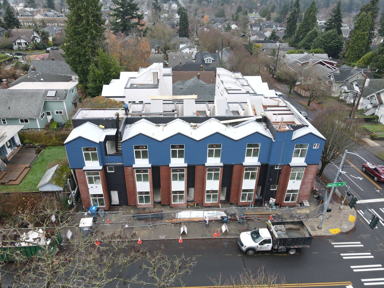 An aerial view of a building under construction in a city