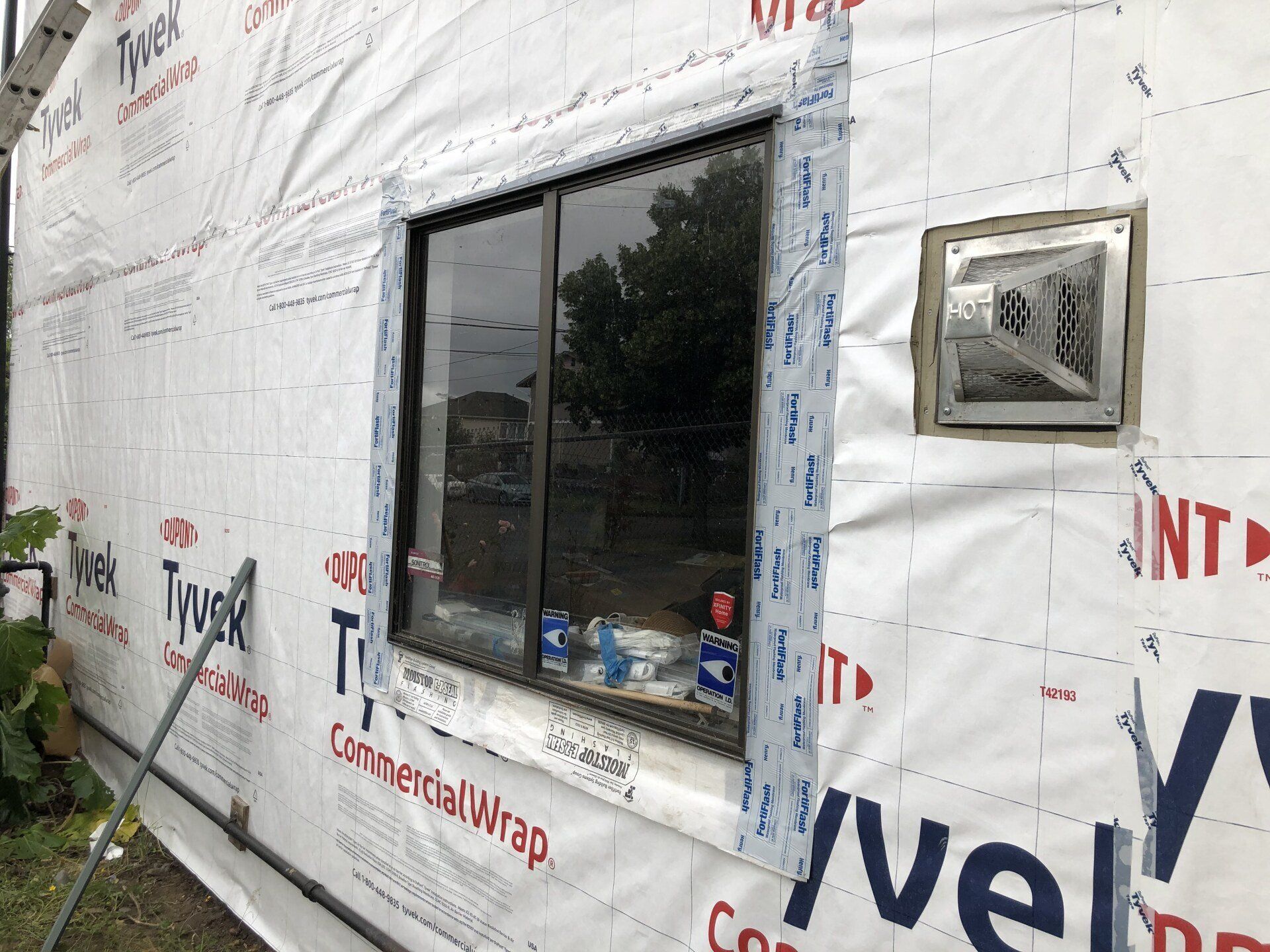 A window is being installed on the side of a building.