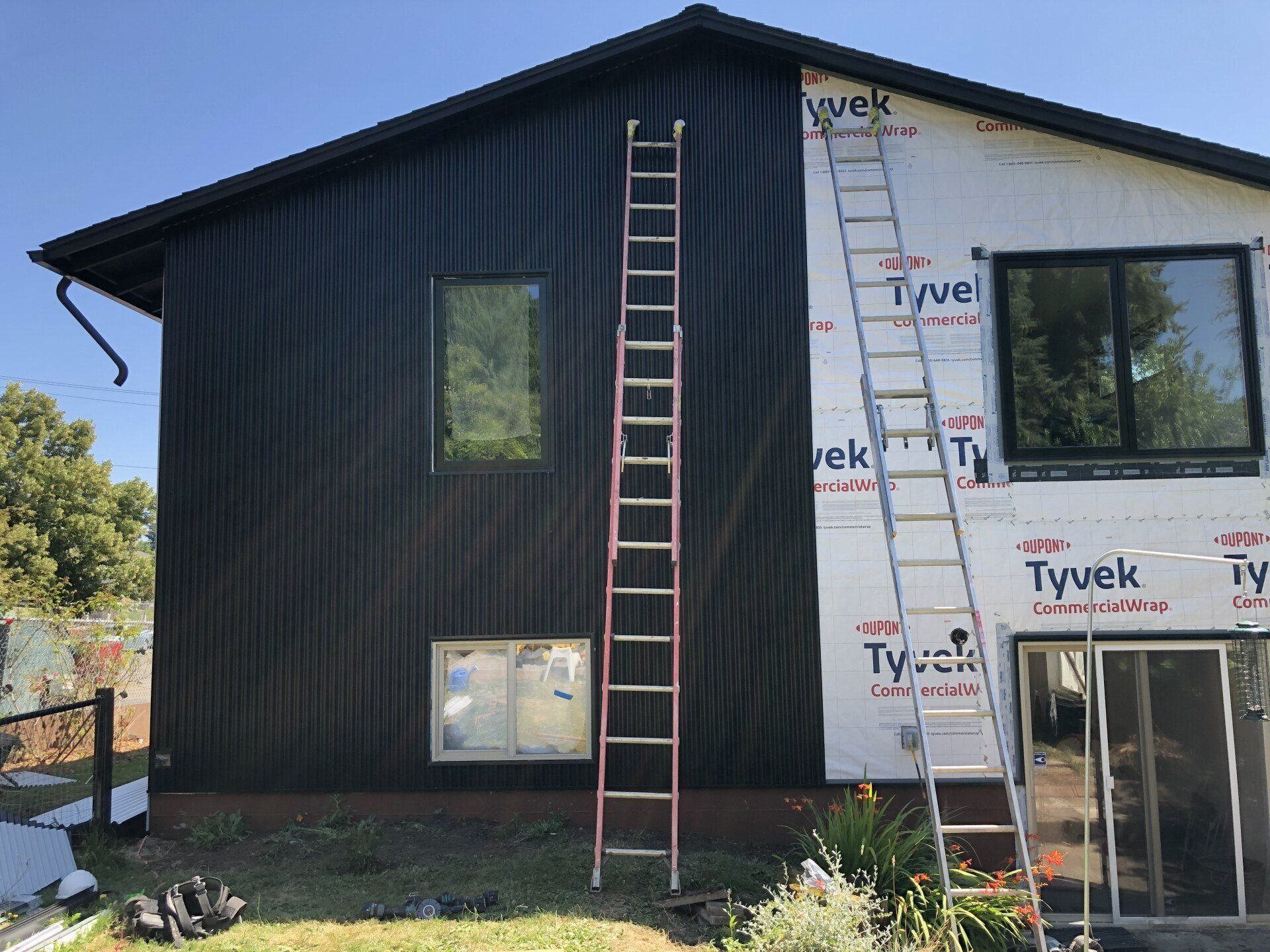 A ladder is leaning against the side of a house.
