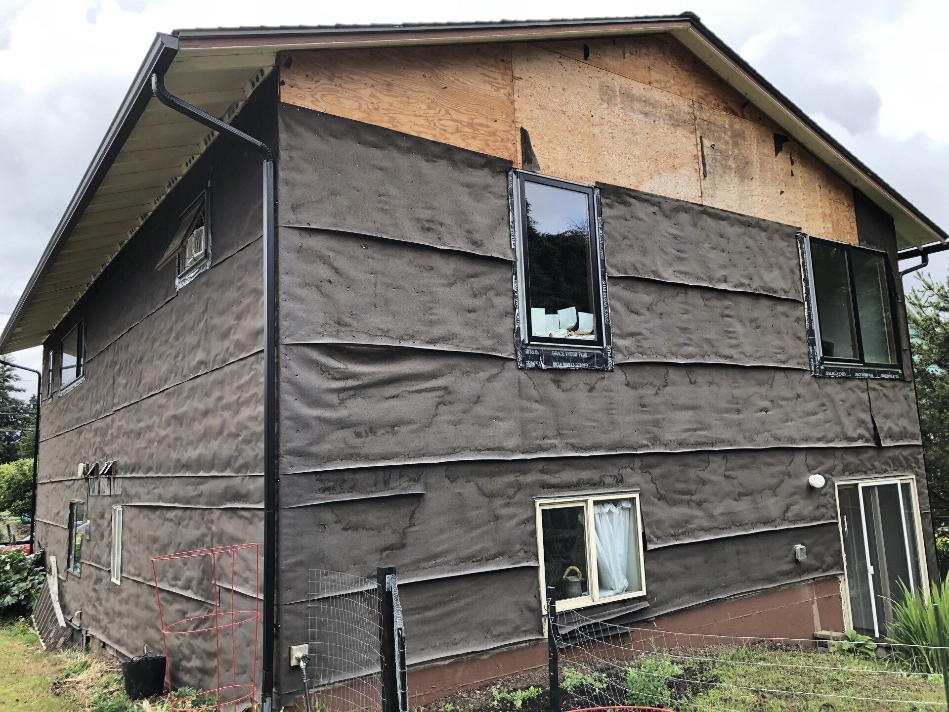 A large house with a lot of windows and siding on it.
