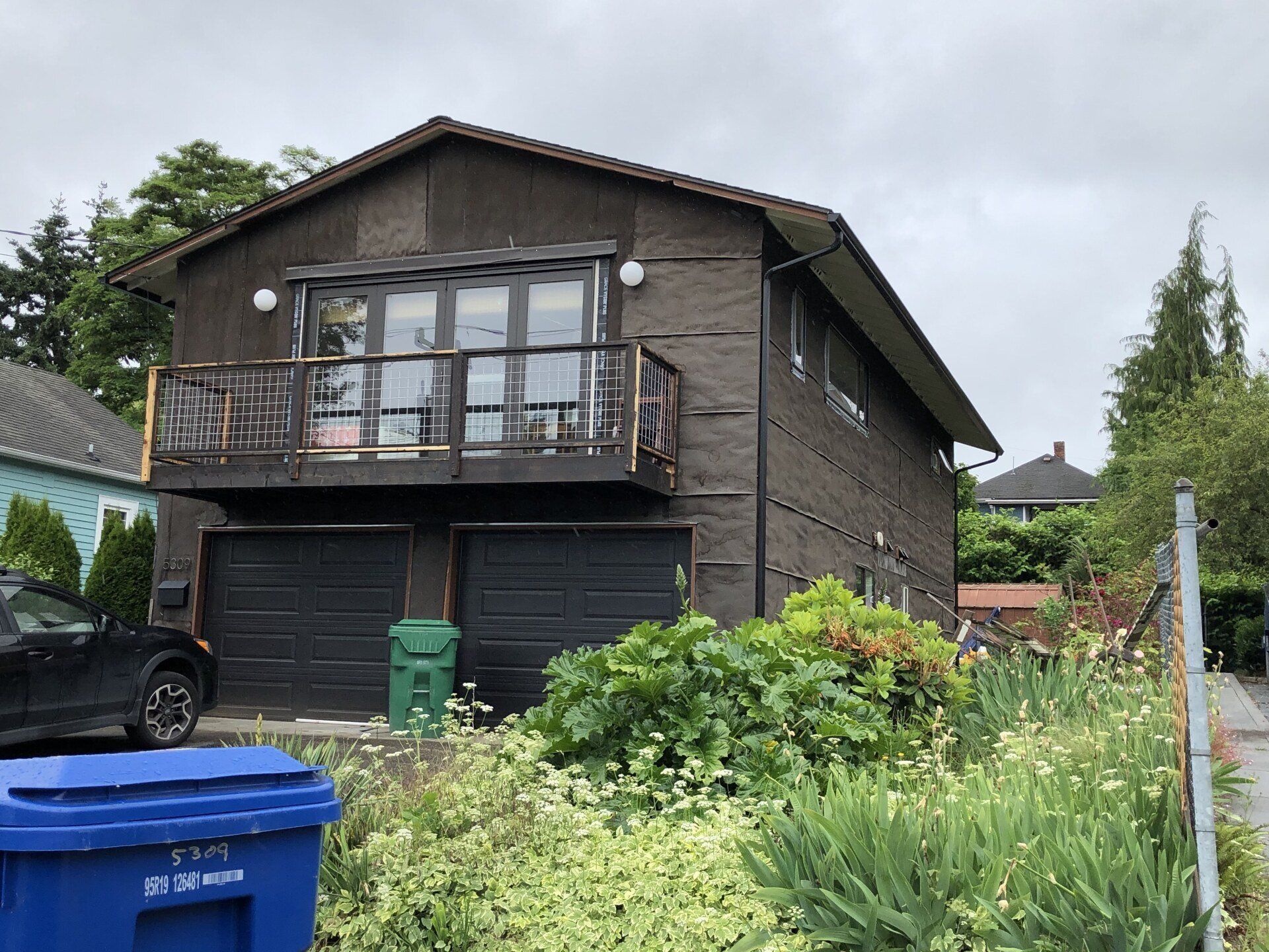 A large house with a car parked in front of it.