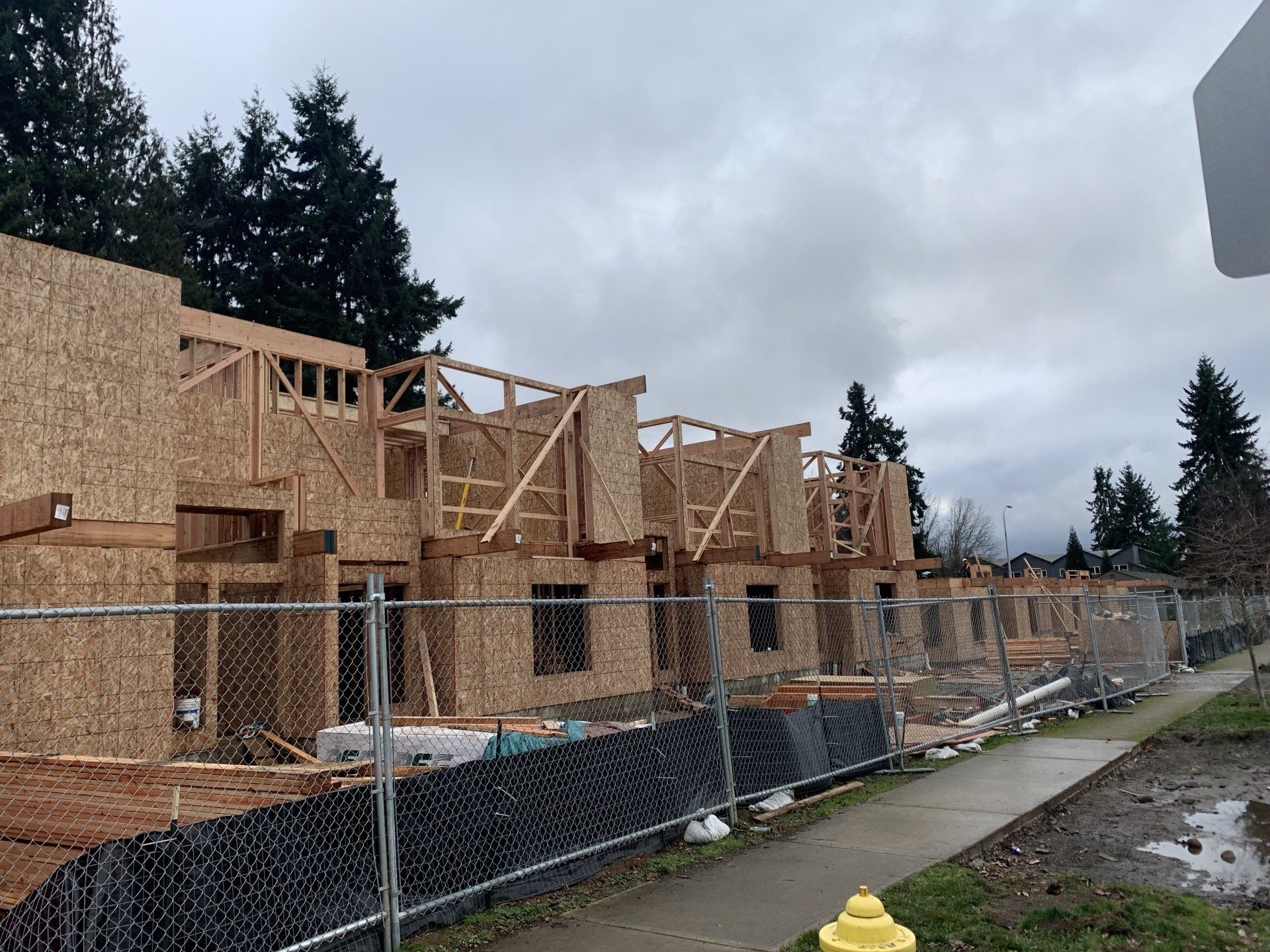 A building under construction with a chain link fence around it.