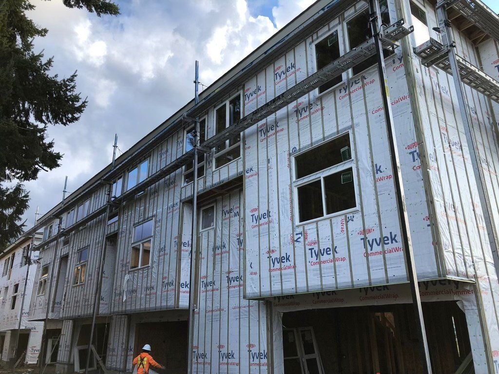 A large building with a lot of windows is being built.