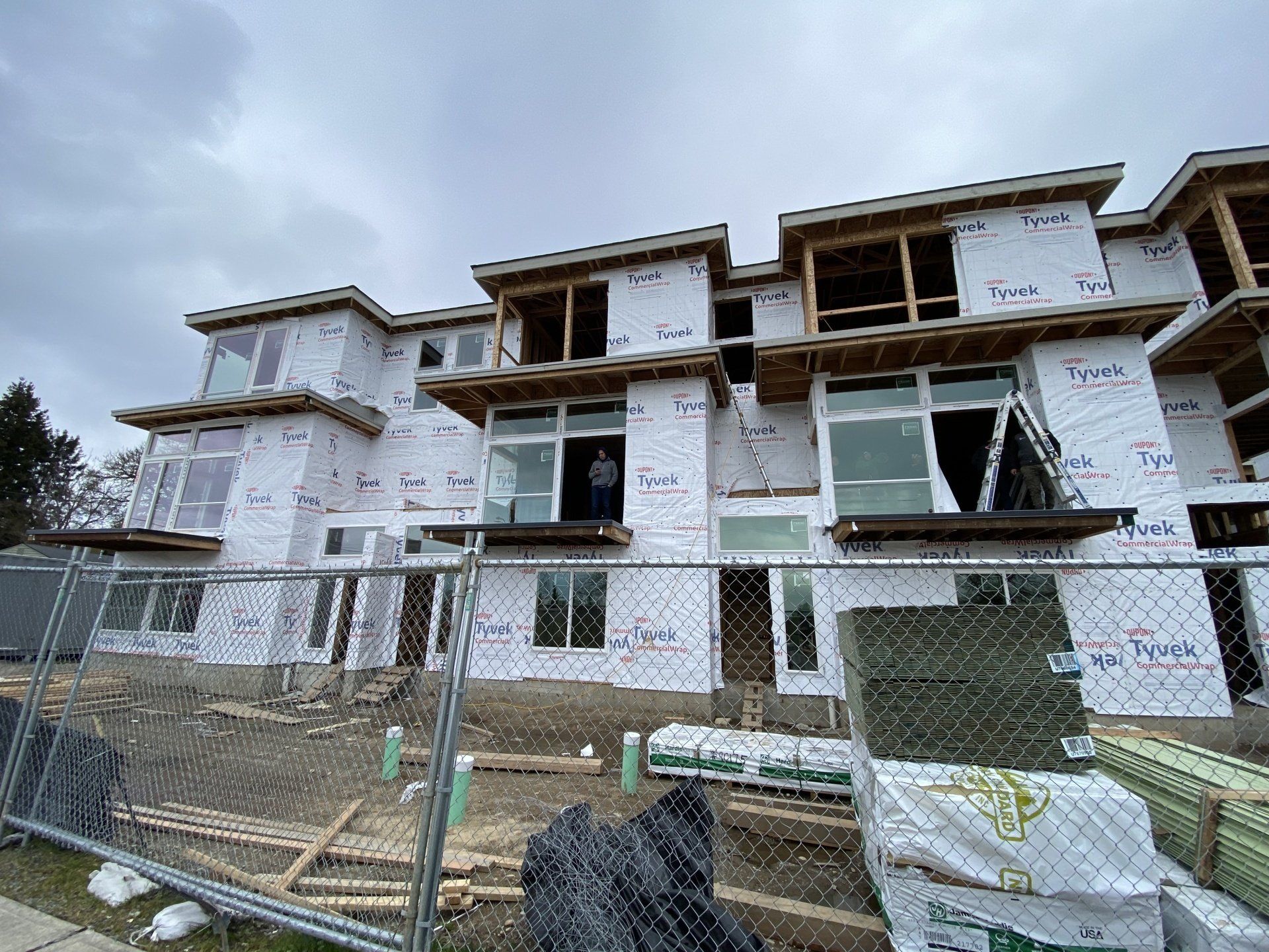A large building under construction with a fence around it.