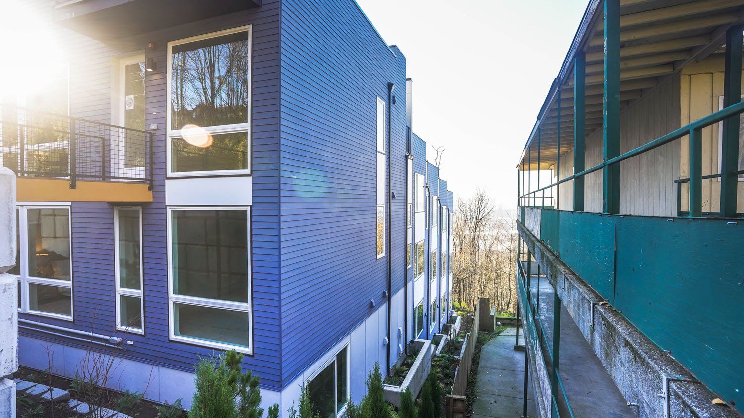A blue building with a lot of windows and balconies
