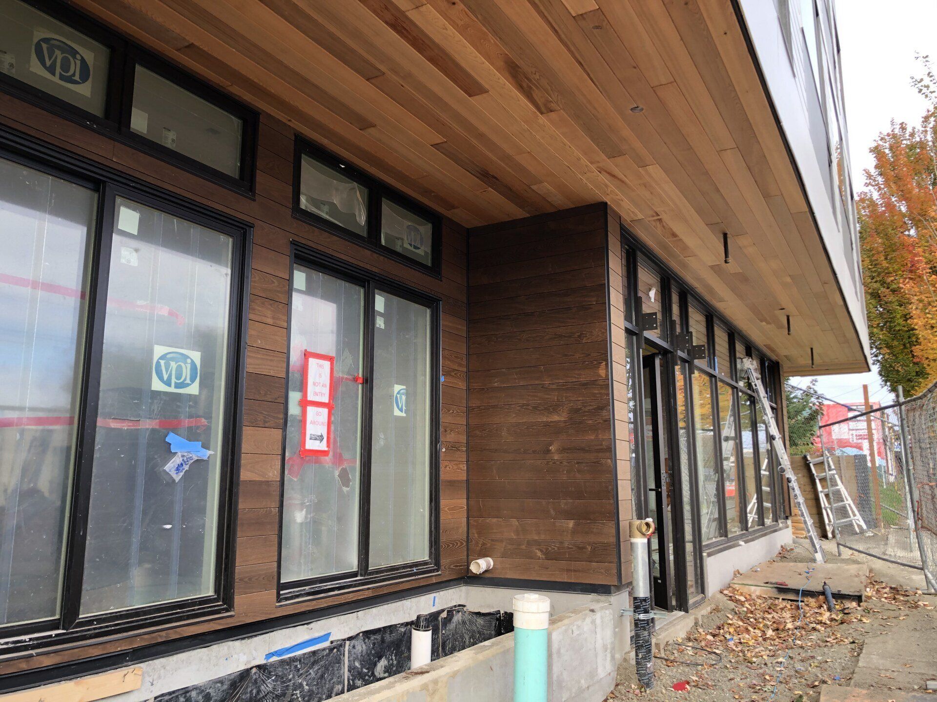 A building under construction with a lot of windows and a wooden ceiling.