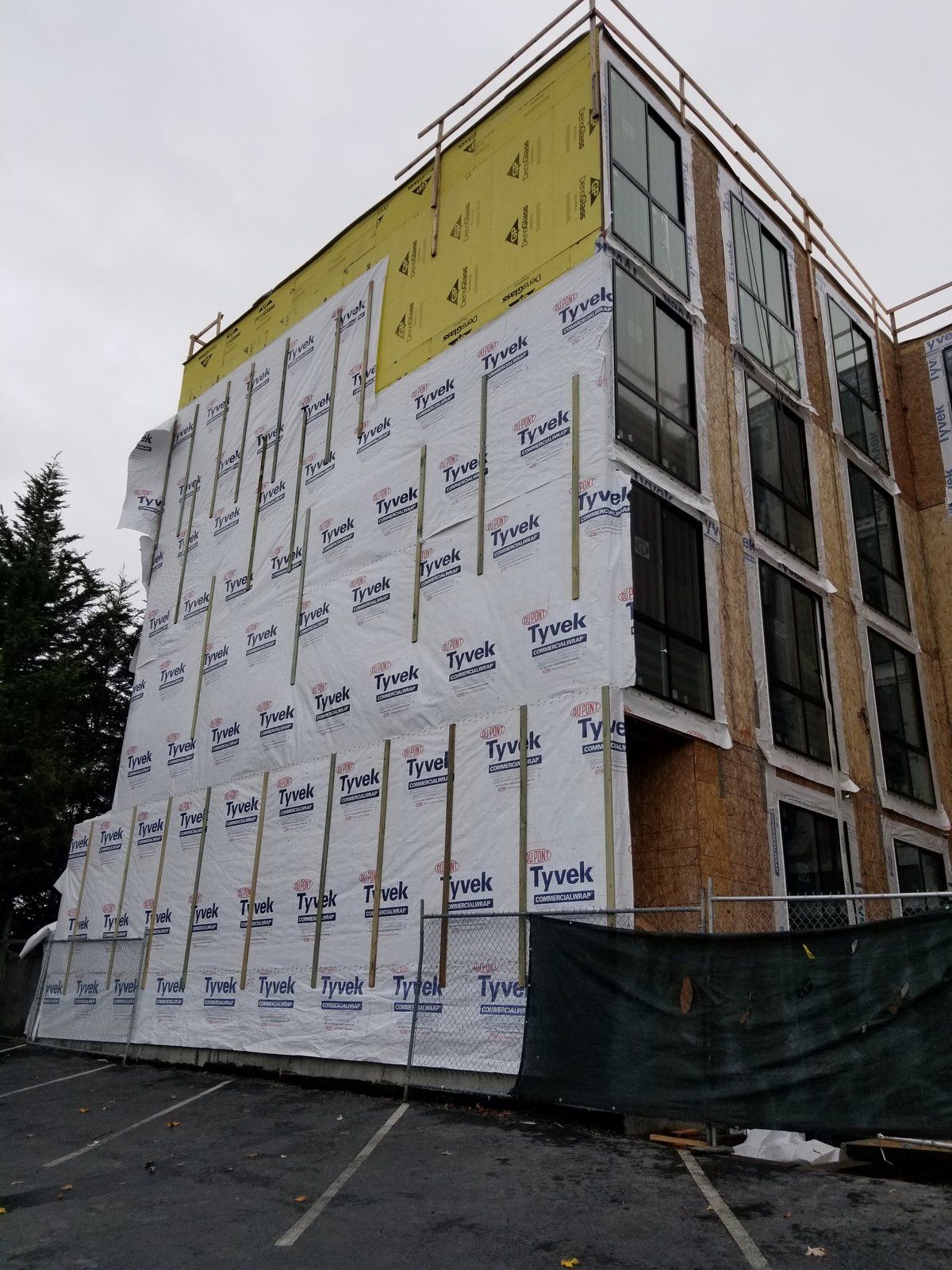 A large building with a lot of windows is being built