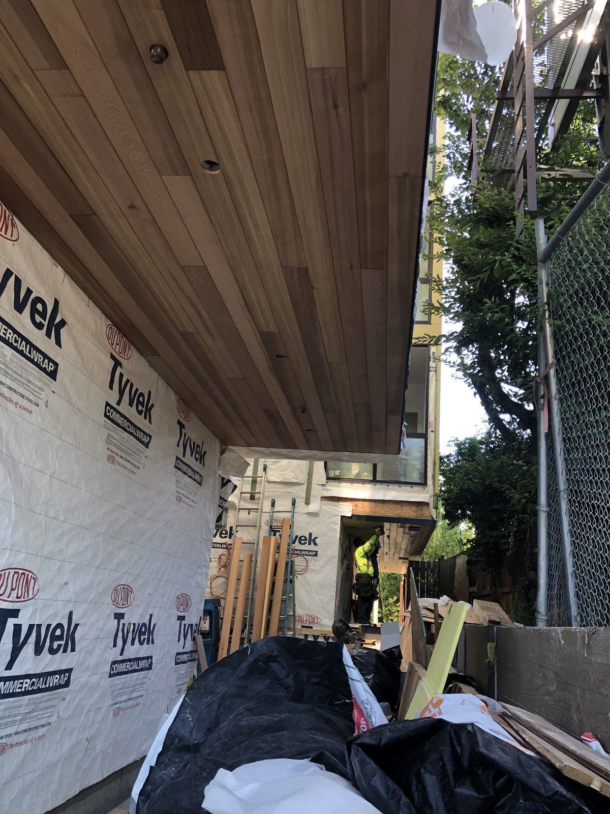 A building under construction with a ceiling made of wood and styrofoam.
