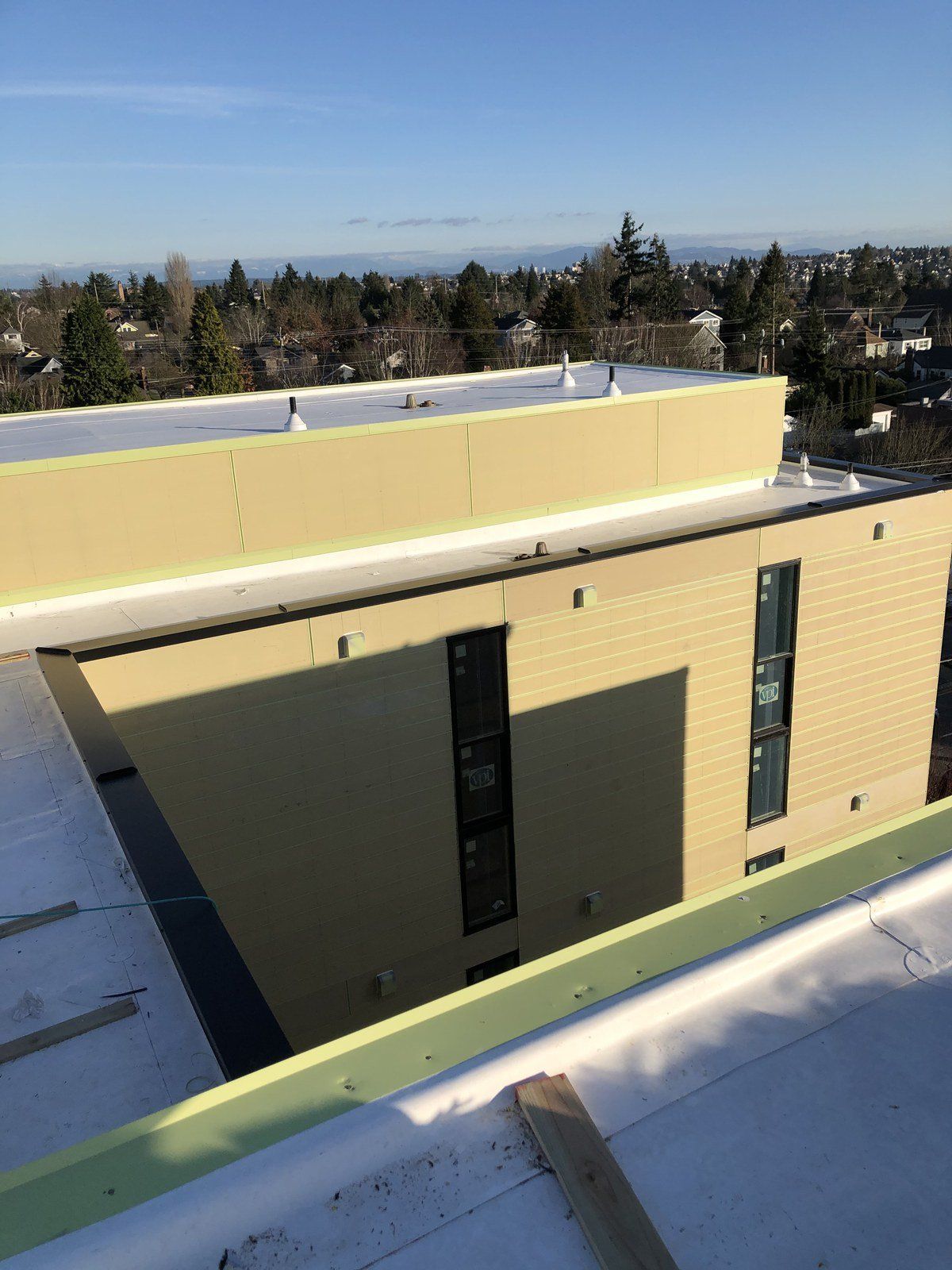 An aerial view of a building with a white roof.