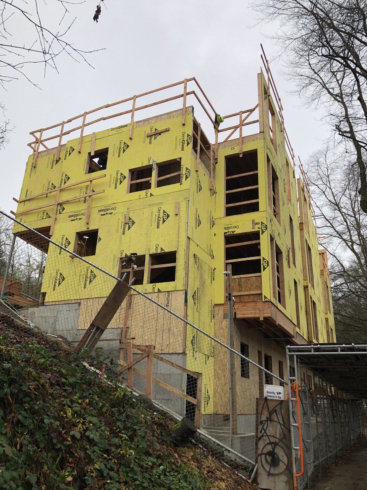 A large building is being built on top of a hill.