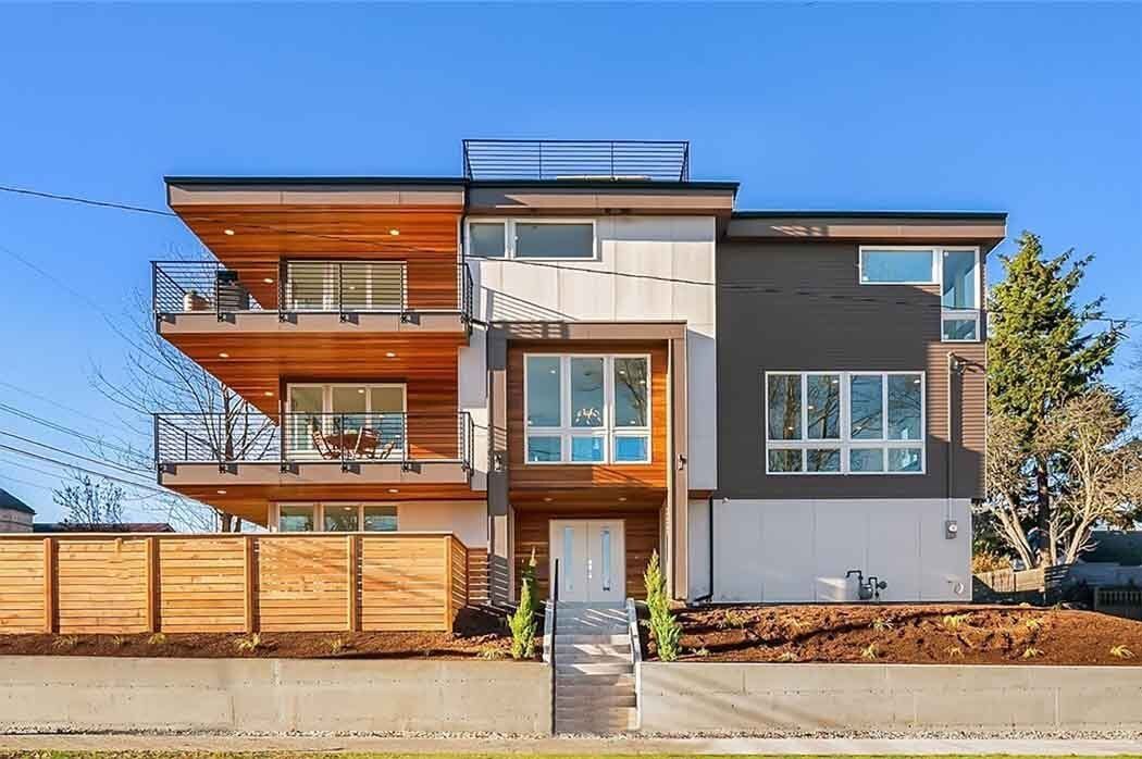 A large modern house with a lot of windows and balconies.