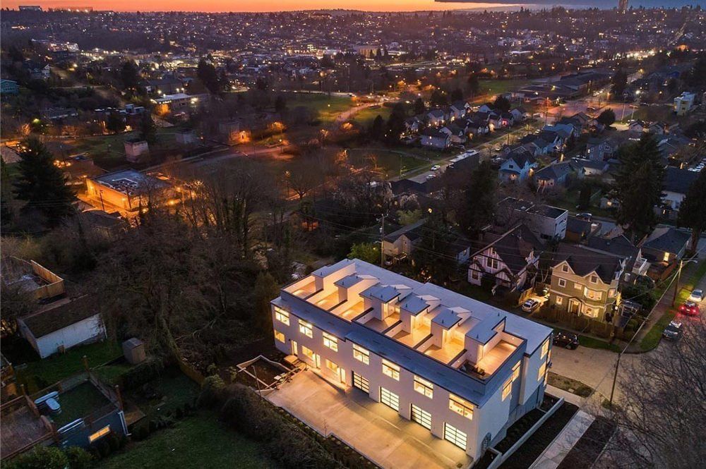 An aerial view of a building in a residential area at night