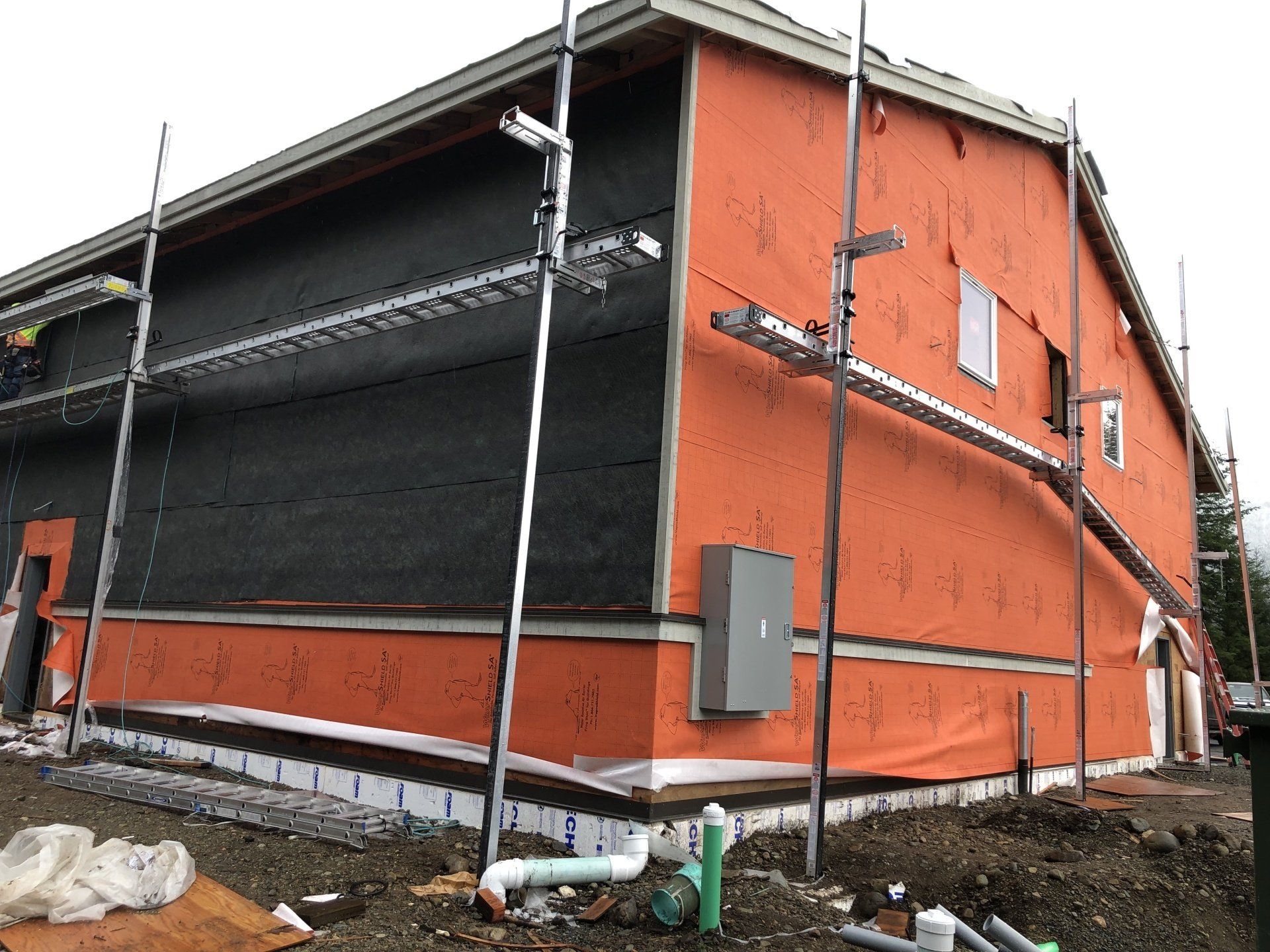 A large orange building with scaffolding on the side is being built.