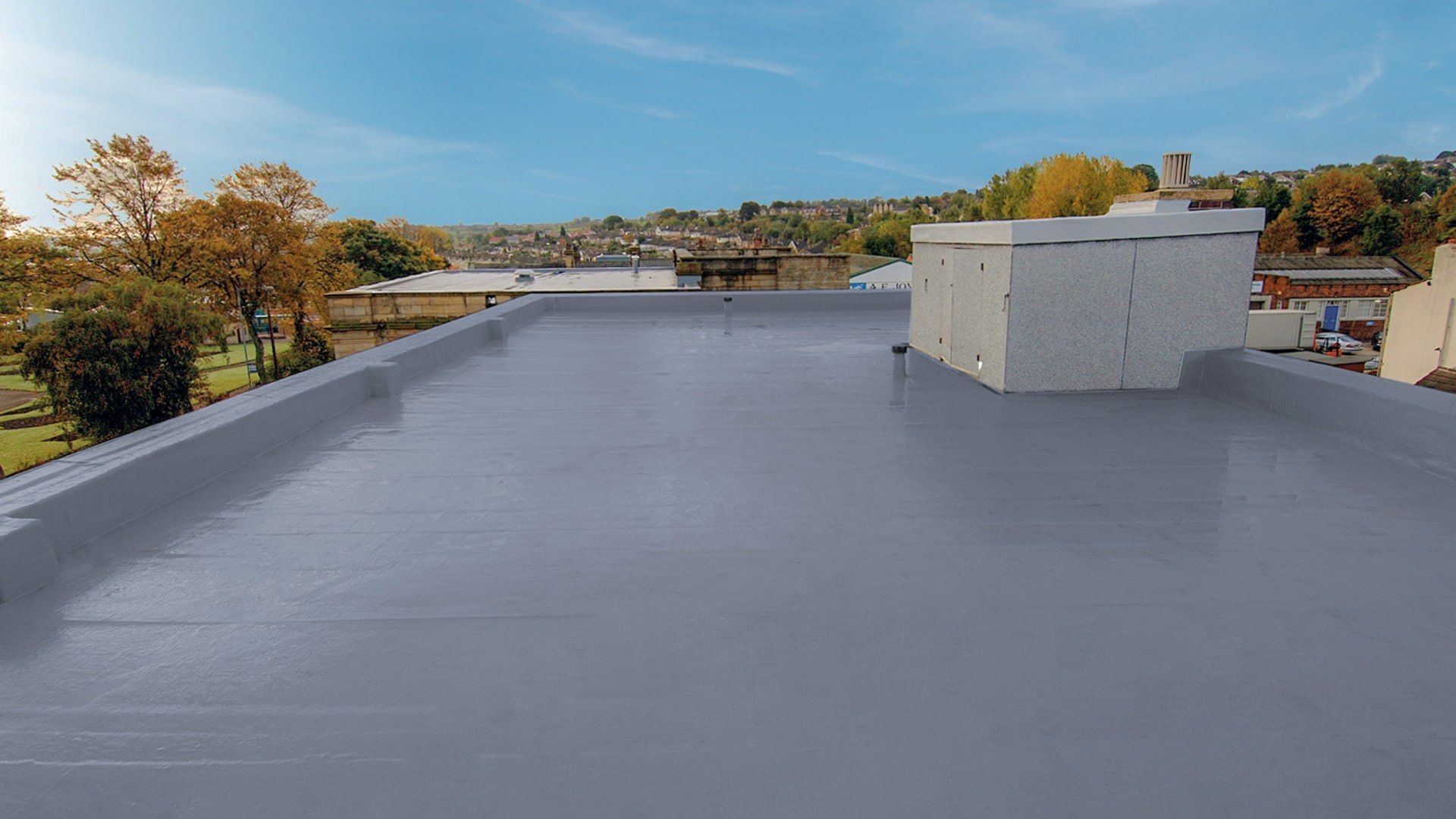 A roof with a chimney on top of it and trees in the background.