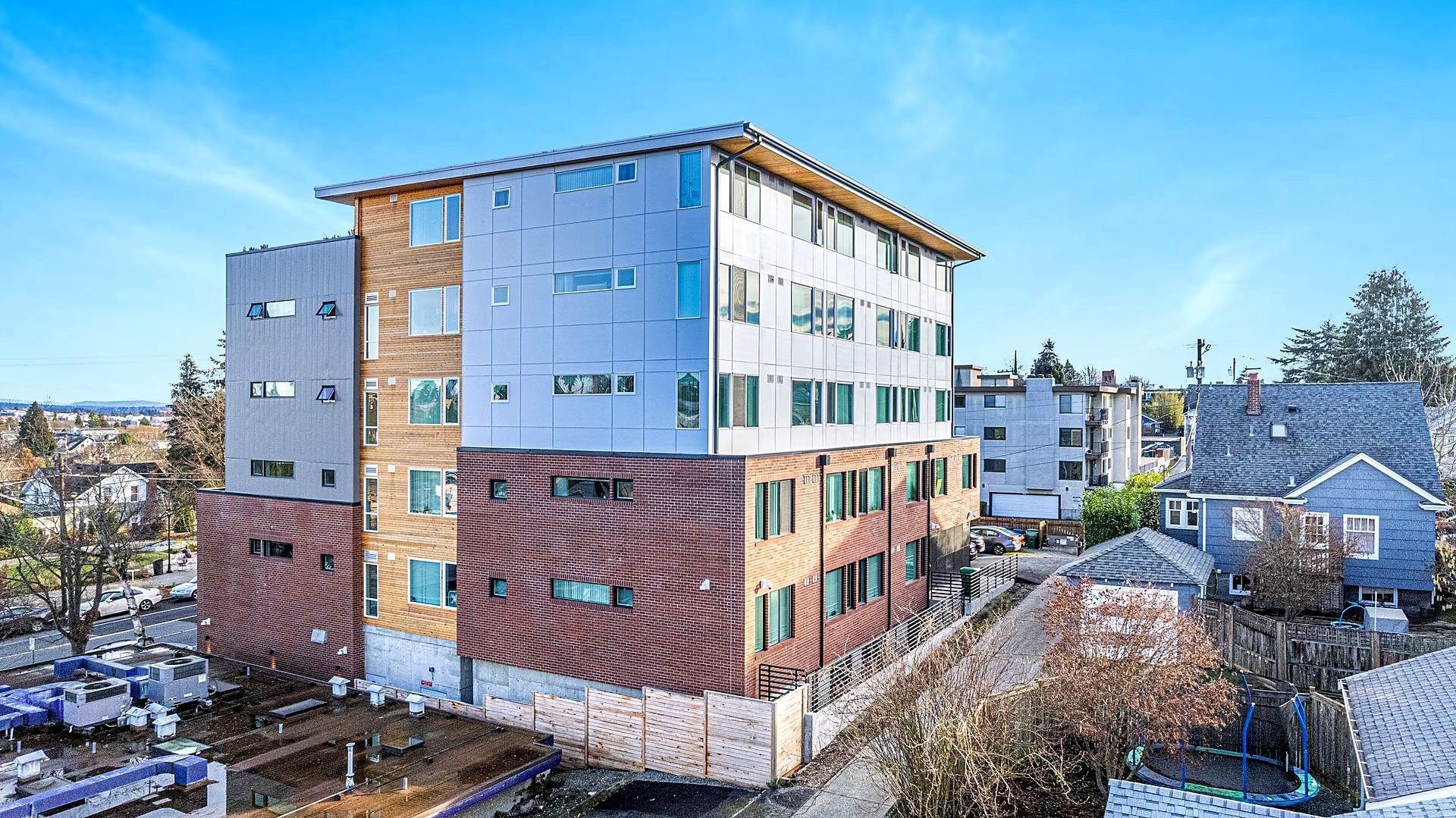 An aerial view of a large apartment building in a city.