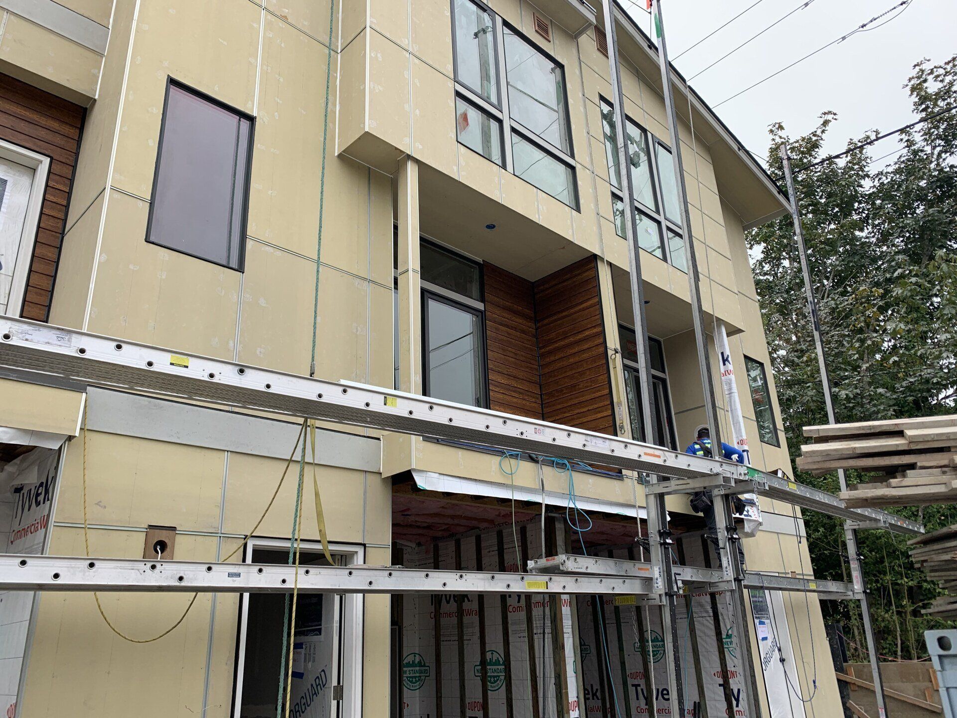 A house is being built with a lot of windows and scaffolding.