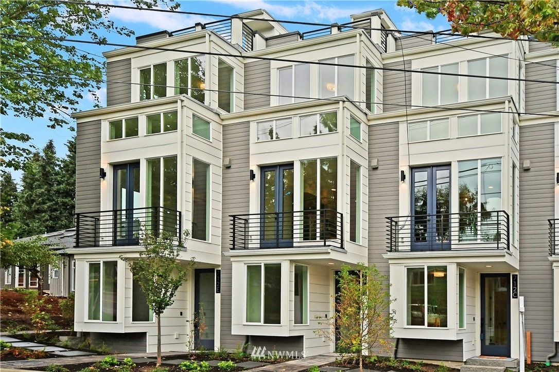 A modern apartment building with a lot of windows and balconies.