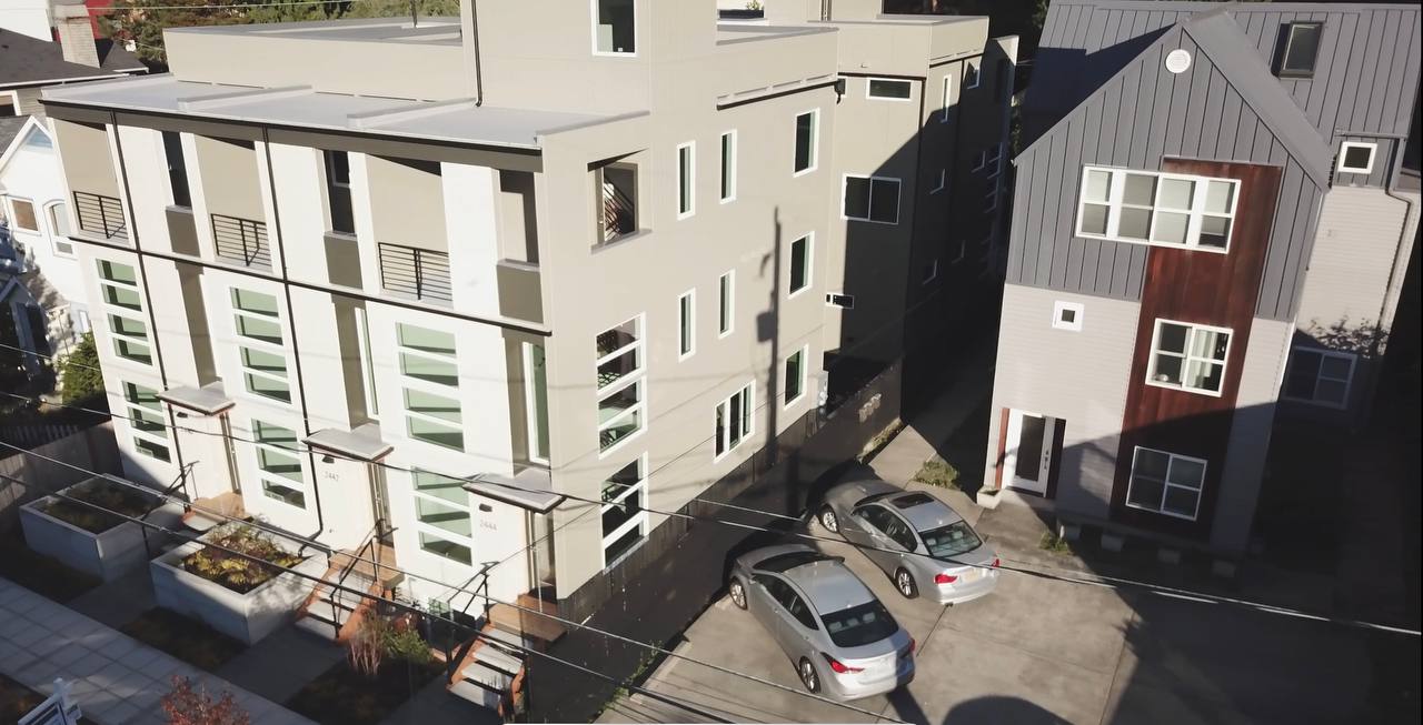 An aerial view of a building with cars parked in front of it.
