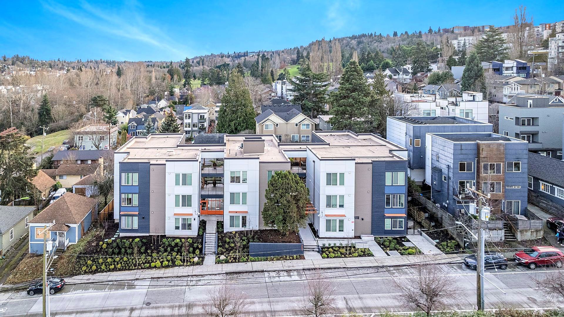 An aerial view of a large apartment building in a residential area.