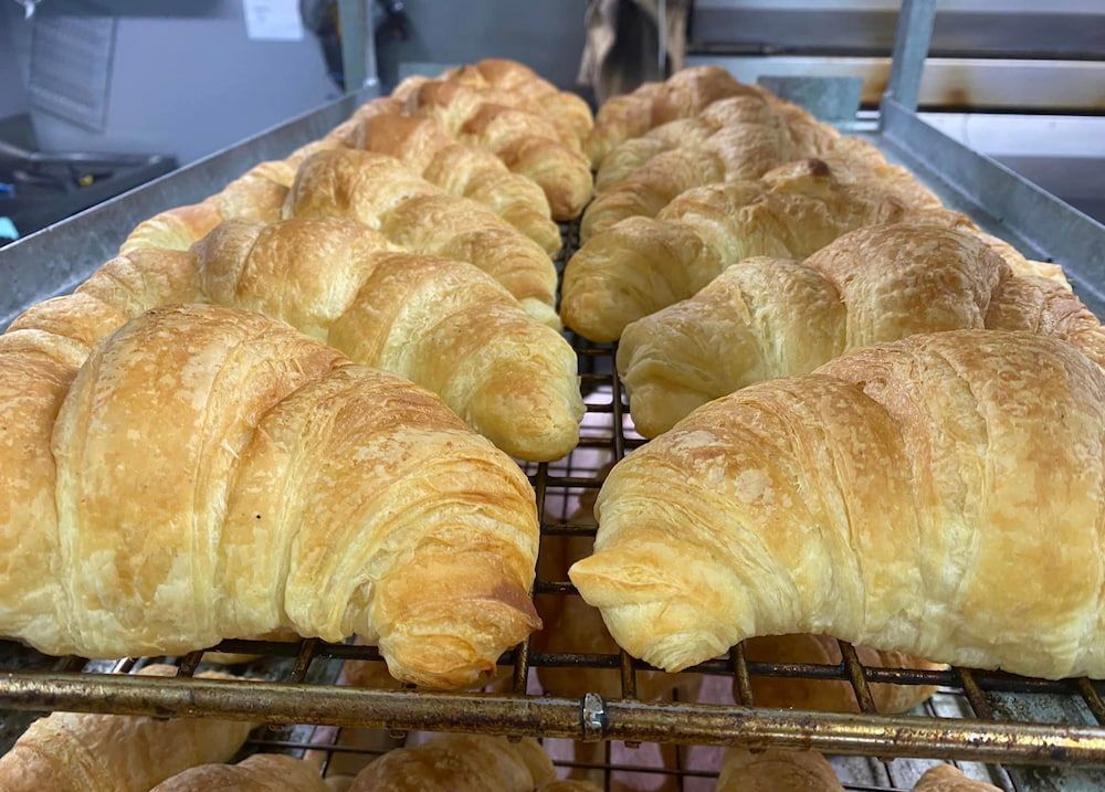 A Display Case Filled With A Variety Of Pastries And Cakes — Cedar Park Bakehouse in Taranganba, QLD