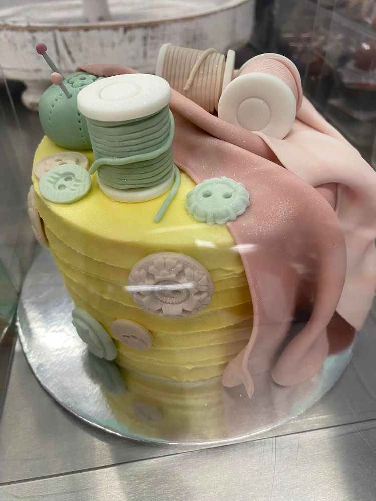 A Cake With Spools Of Thread And Buttons On It — Cedar Park Bakehouse in Taranganba, QLD