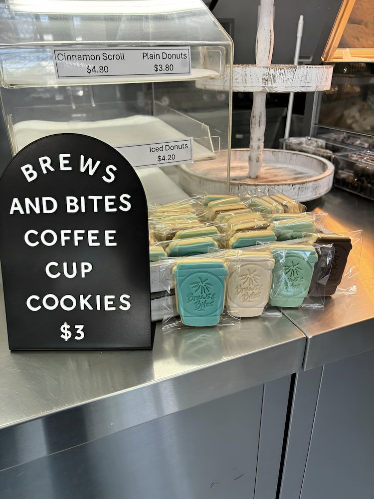 A Display Case Filled With Cookies And A Sign That Says  It — Cedar Park Bakehouse in Taranganba, QLD