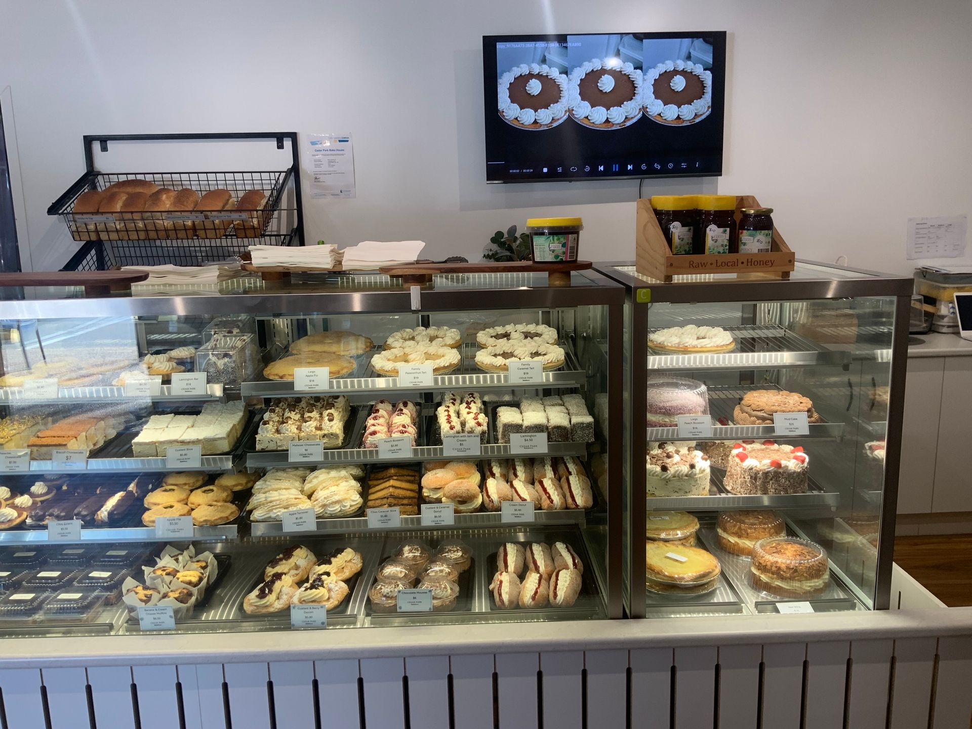 A Display Case Filled With A Variety Of Pastries And Desserts — Cedar Park Bakehouse in Taranganba, QLD