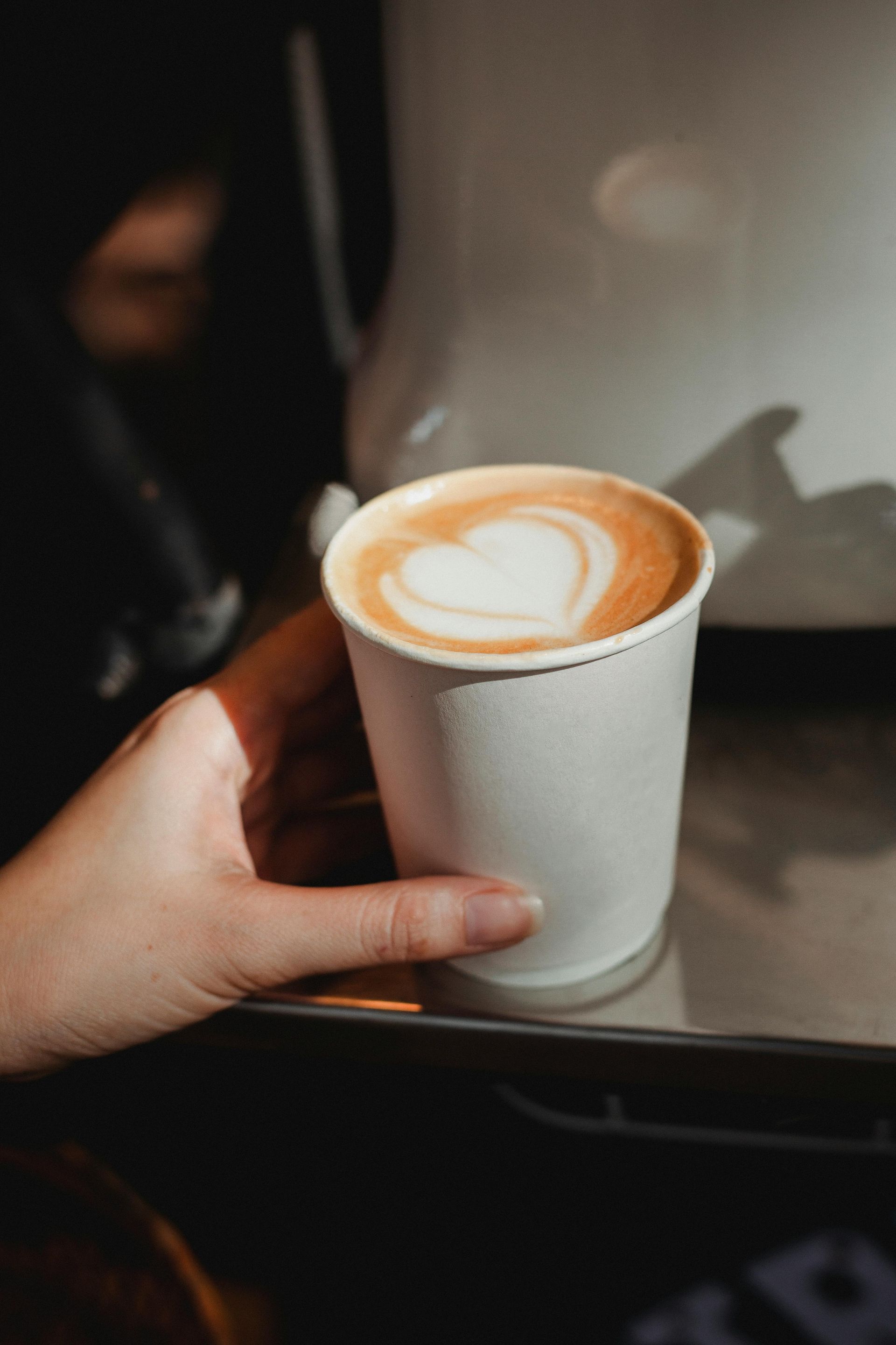 A Cup Of Schibello Coffee Is Sitting On A Counter — Cedar Park Bakehouse in Taranganba, QLD
