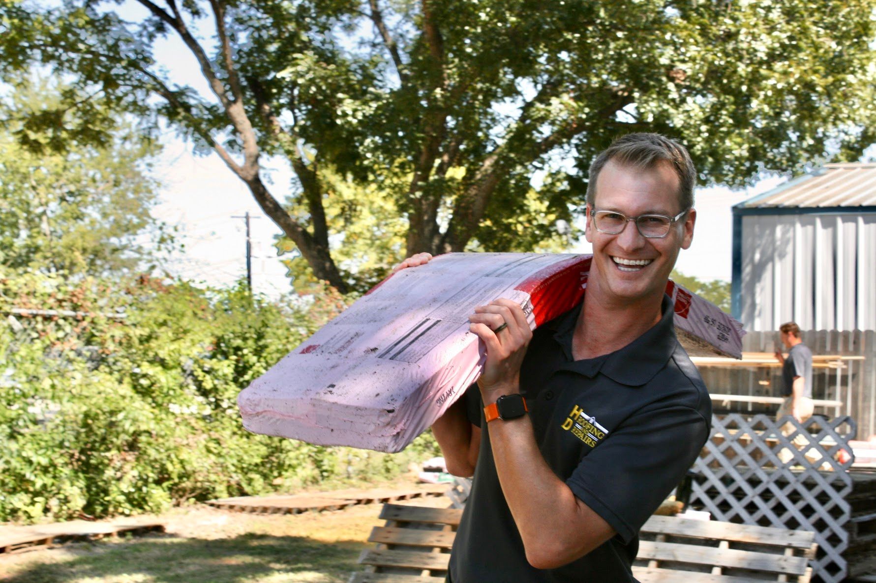 HD Roofing and Repairs team member holding roofing insulation material