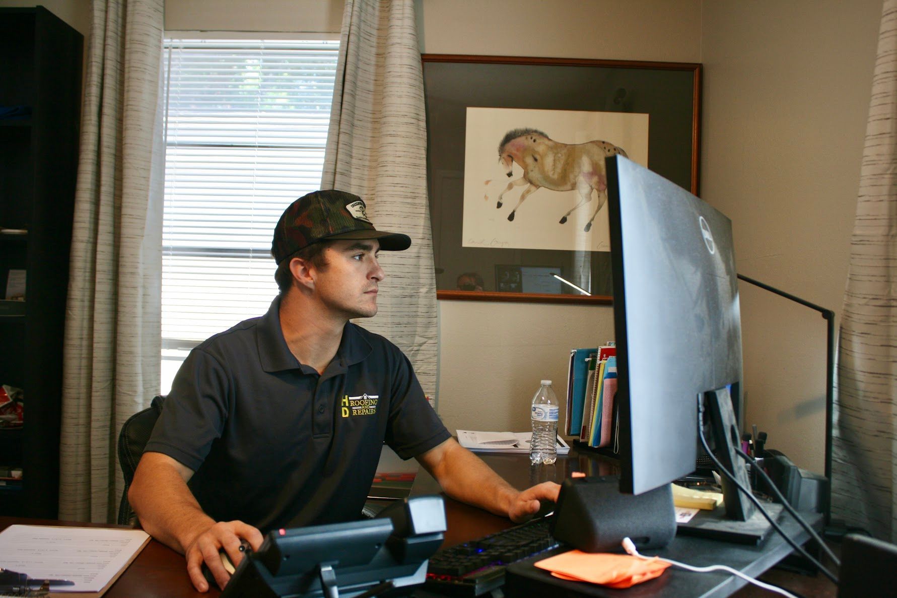 HD Roofing and Repairs team member working in the office