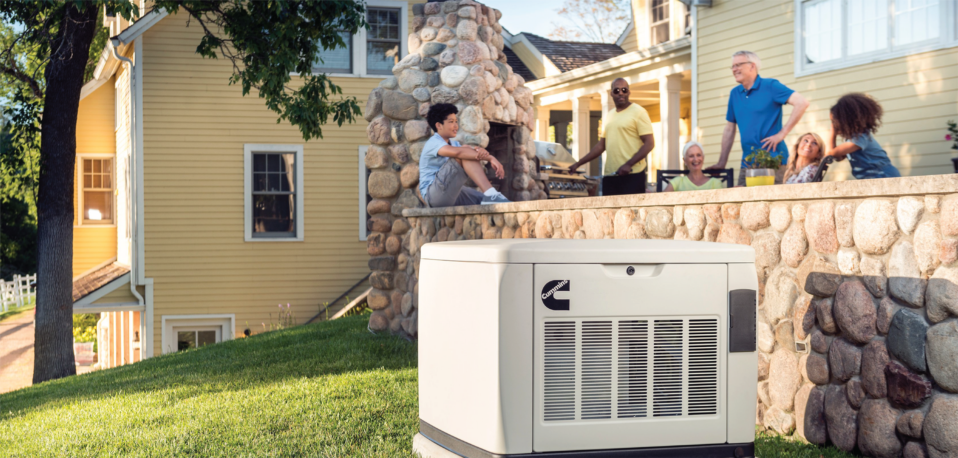 A family enjoying a backyard gathering near a Cummins generator.